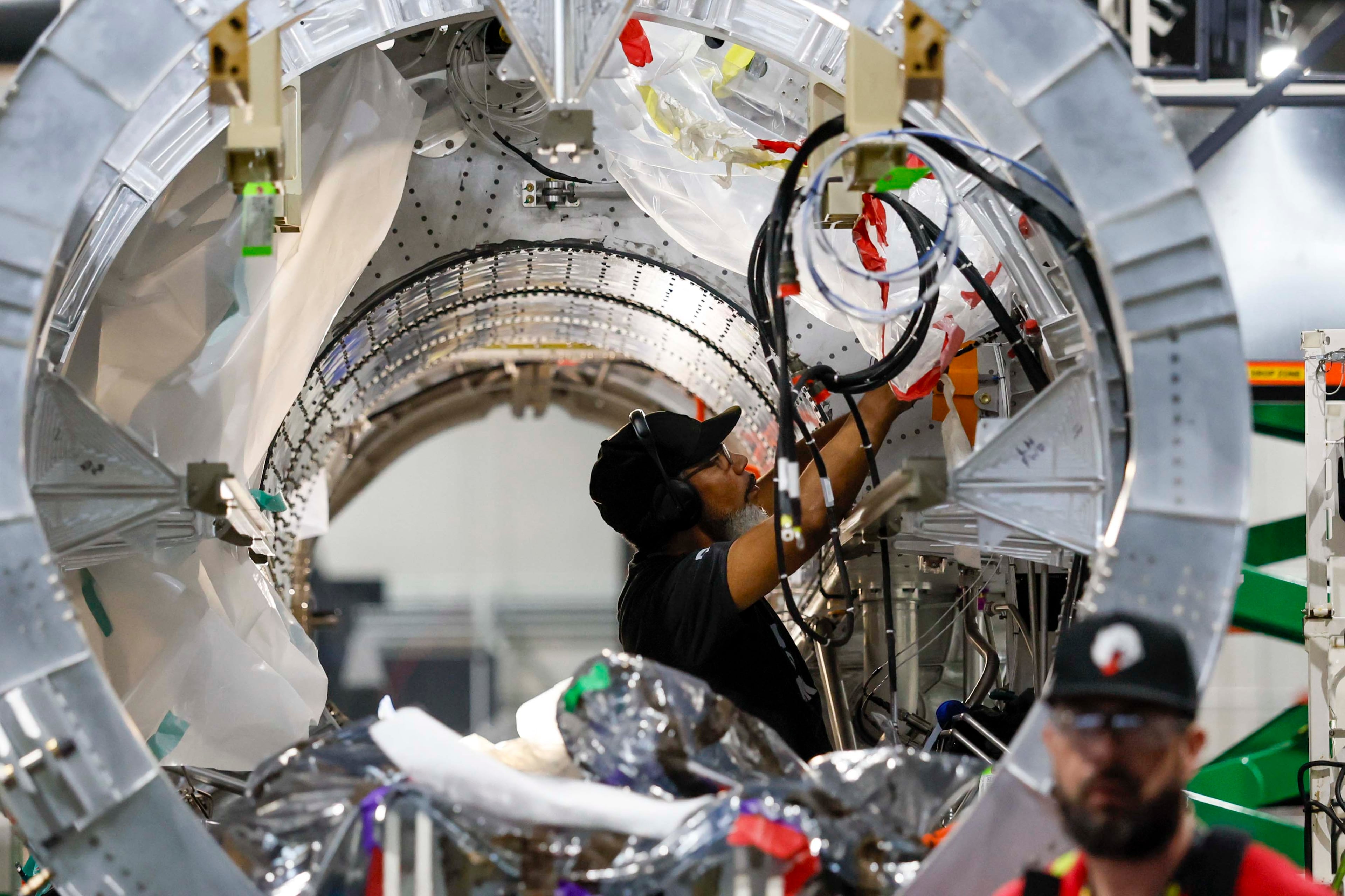 A mechanical engineer is seen working on the Quarterhorse MK 2 aircraft at Hermeus’s Doraville facility on Tuesday, May 12, 2026. Hermeus, a company that specializes in supersonic aircraft, plans to conduct its third test of an uncrewed, remotely piloted aircraft this coming fall. (Miguel Martinez/AJC)