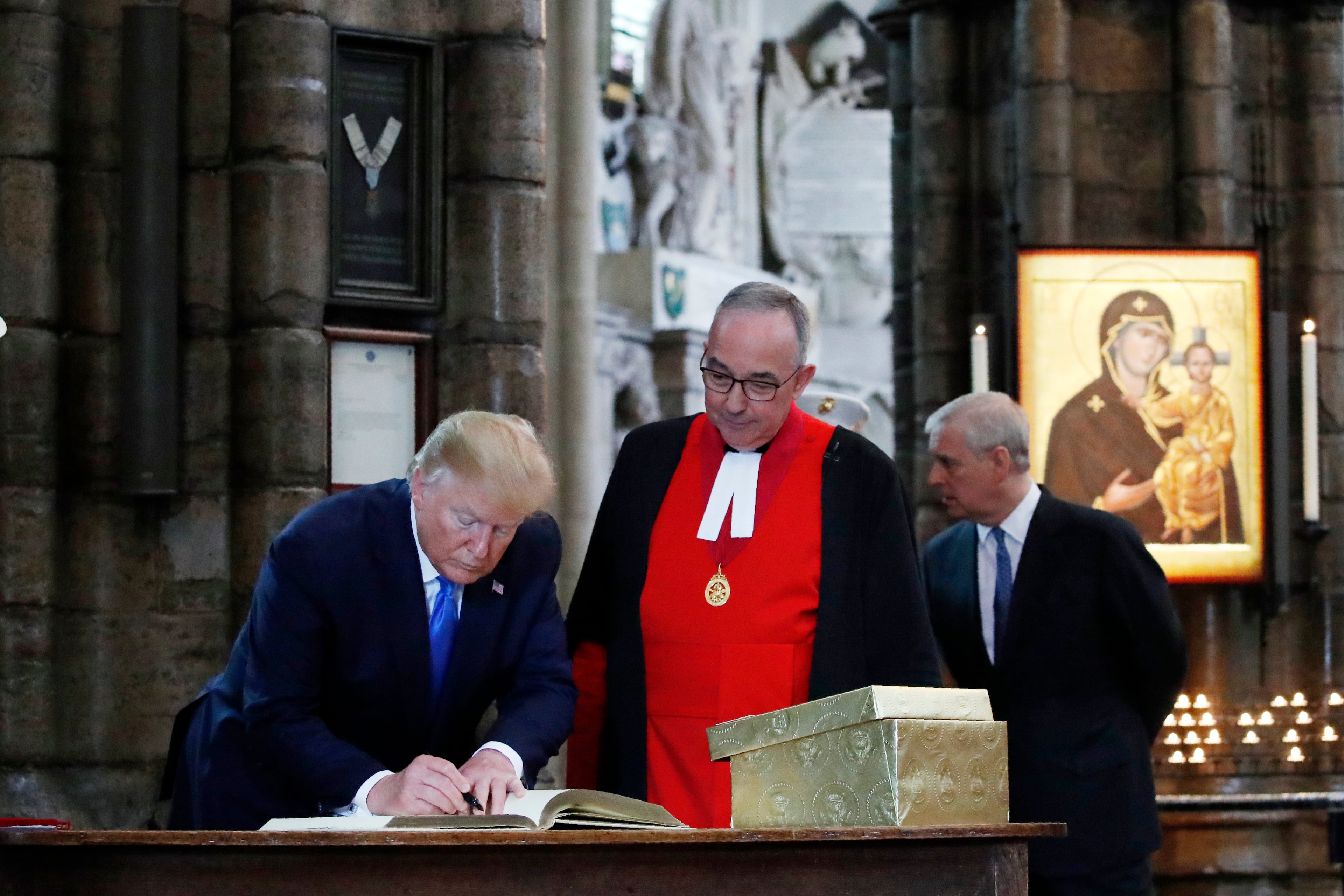President Donald Trump signs the guest book at Westminster Abby, Monday, June 3, 2019, in London. (AP Photo/Alex Brandon)