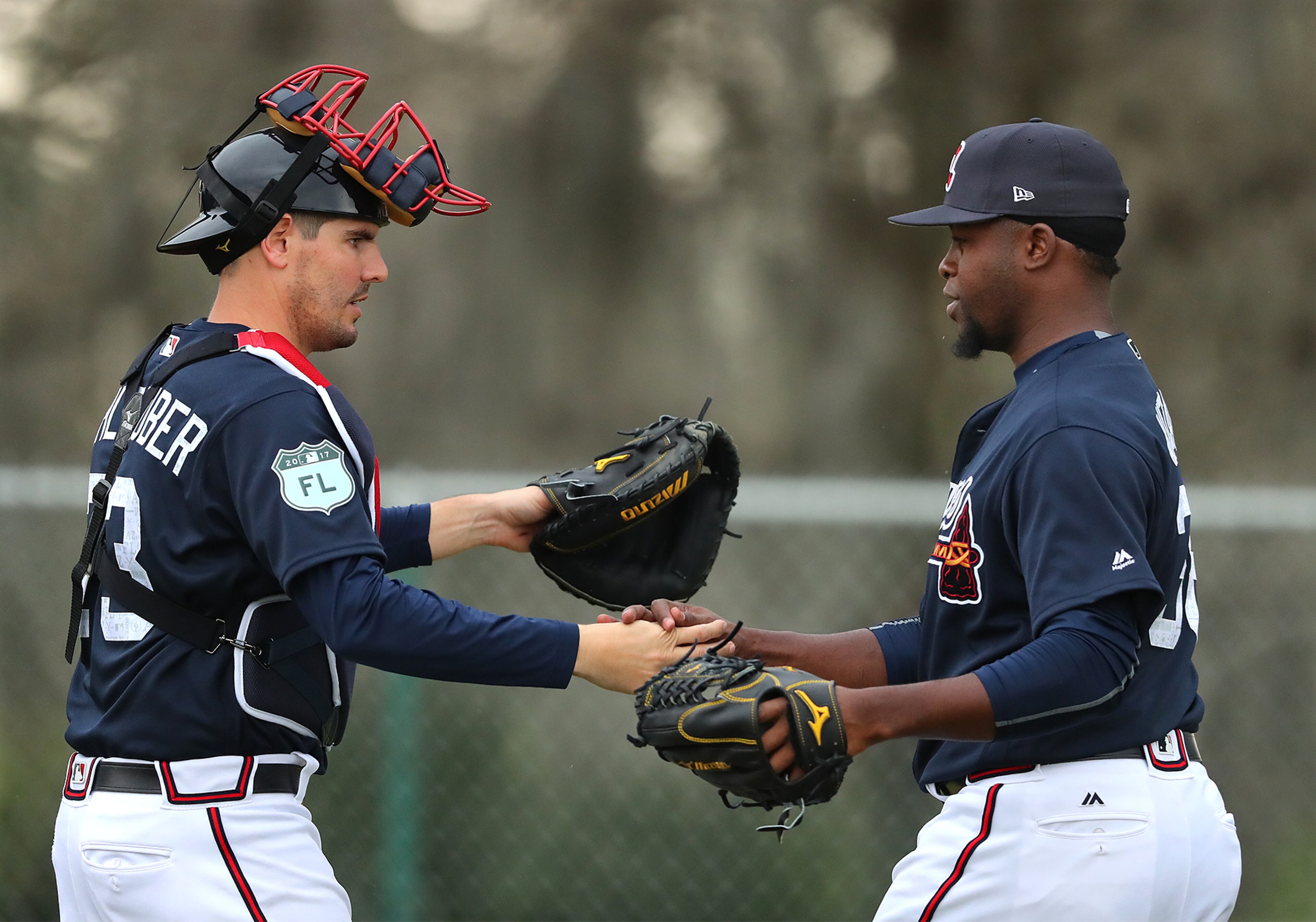 February 18, 2017, Lake Buena Vista, FL: Atlanta Braves catcher Braeden Schlehuber and pitcher Arodys Vizcaino greet each other after a pitching session on the first full squad workout at Champion Stadium on Saturday Feb. 18, 2017, at the ESPN Wide World of Sports in Lake Buena Vista. Curtis Compton/ccompton@ajc.com