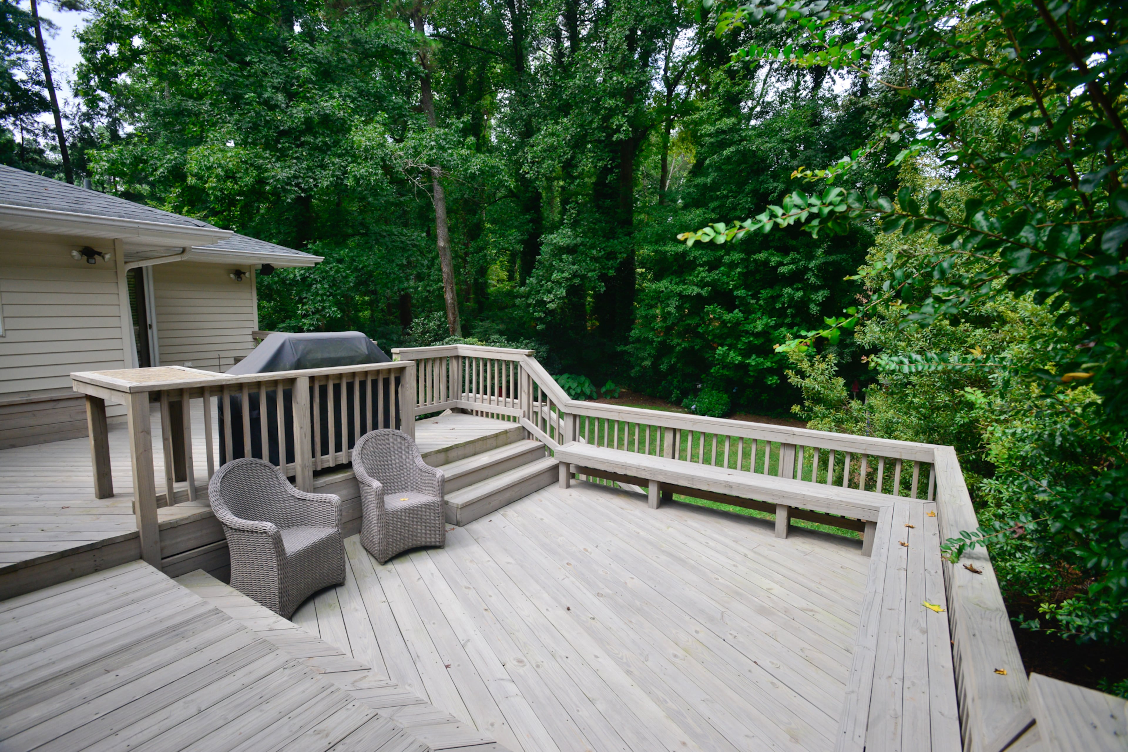 A gray washed stain added a weathered look to the deck, which has a gas grill and an island.