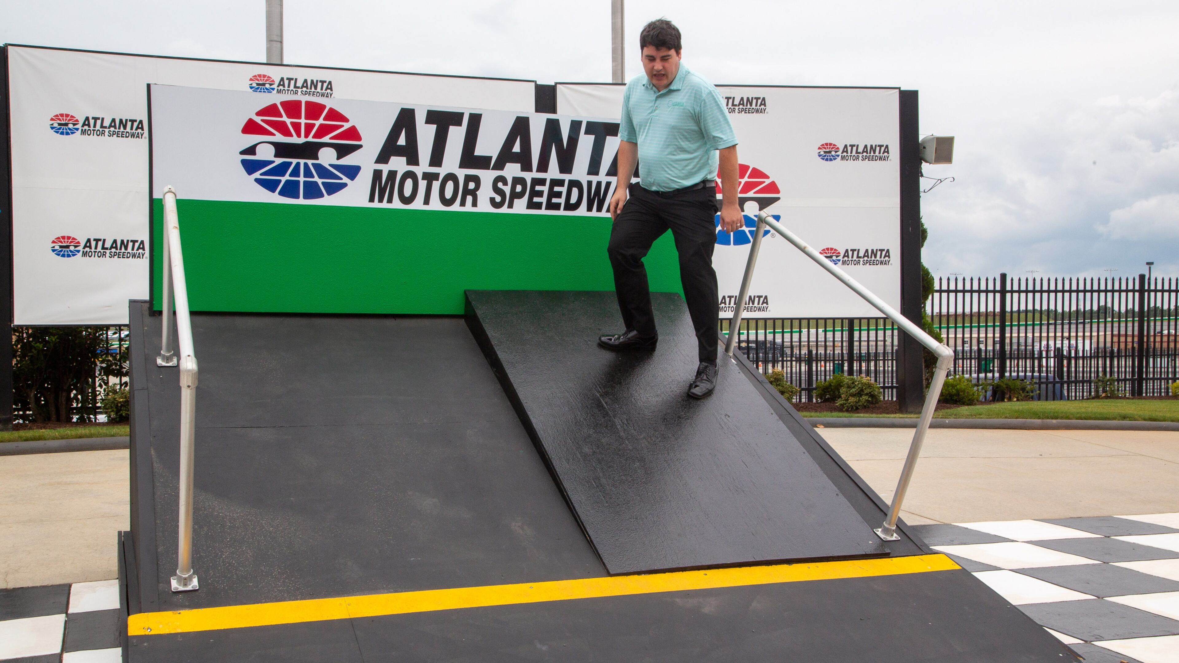 Tyler Head stands on the mock-up showing the difference between the old track and the planned new changes to the Atlanta Motor Speedway Tuesday, July 6, 2021, in Hampton. (Steve Schaefer/For the AJC)