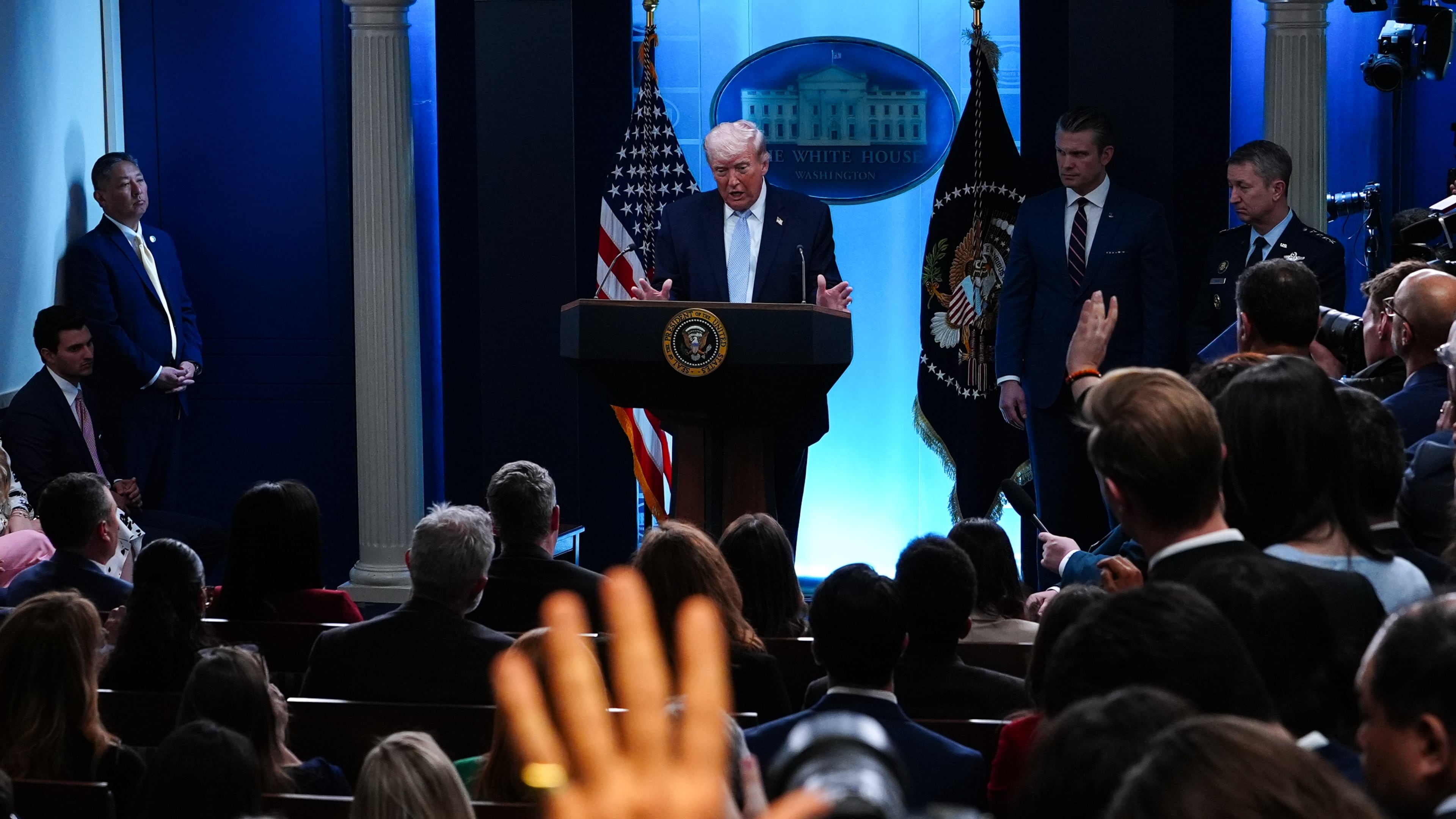 President Donald Trump, accompanied by Defense Secretary Pete Hegseth and Chairman of the Joint Chiefs of Staff Gen. Dan Caine, speaks with reporters in the James Brady Press Briefing Room at the White House, Monday, April 6, 2026, in Washington. (AP Photo/Julia Demaree Nikhinson)