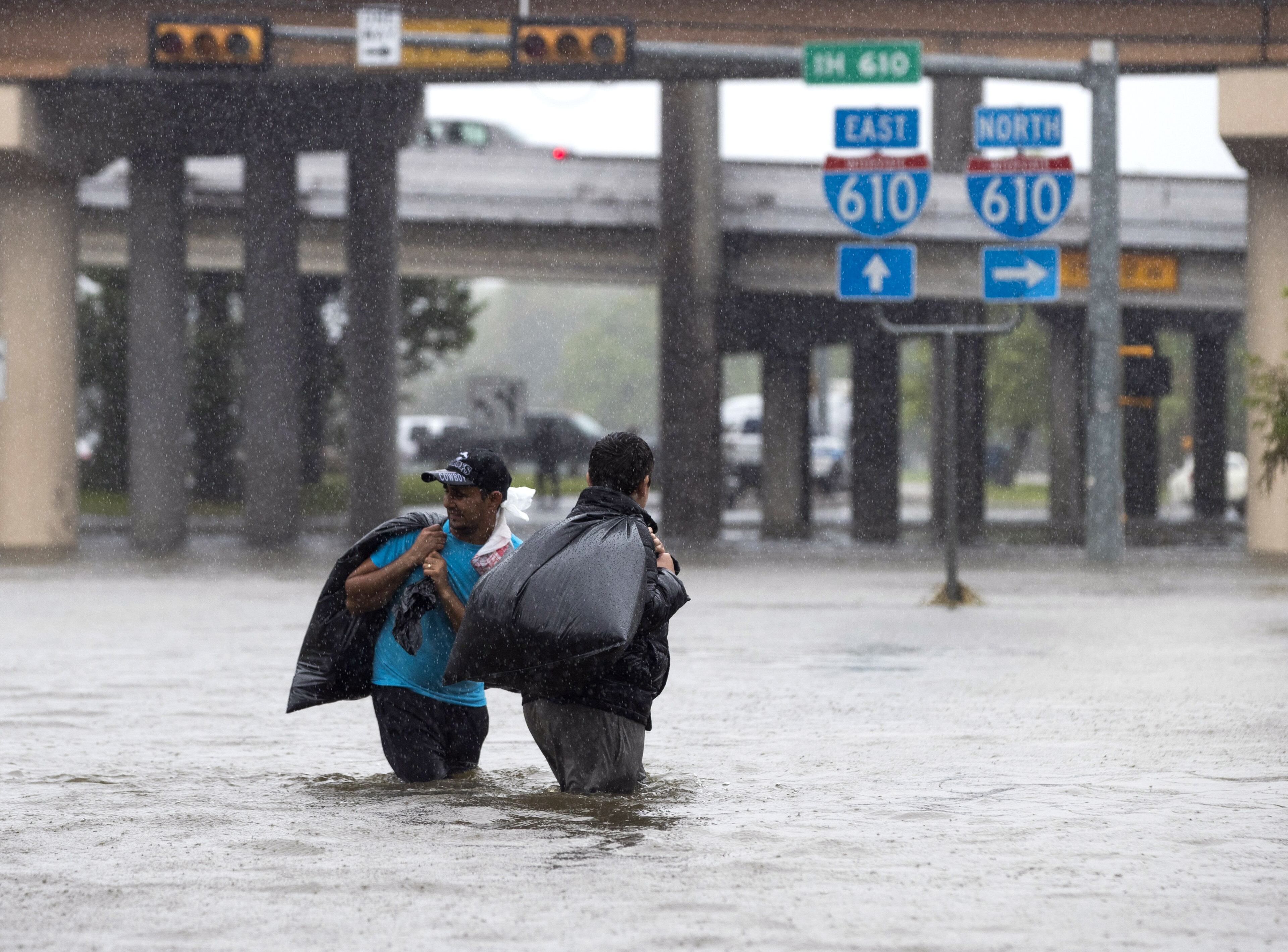 HOUSTON, TX - AUGUST 28: Houston Fire Department Dive Team members motor through high water on North Braeswood Blvdlooking for victims of the flooding from Hurricane Harvey August 28, 2017 in Houston, Texas. Harvey, which made landfall north of Corpus Christi late Friday evening, is expected to dump upwards to 40 inches of rain in areas of Texas over the next couple of days. (Photo by Erich Schlegel/Getty Images)