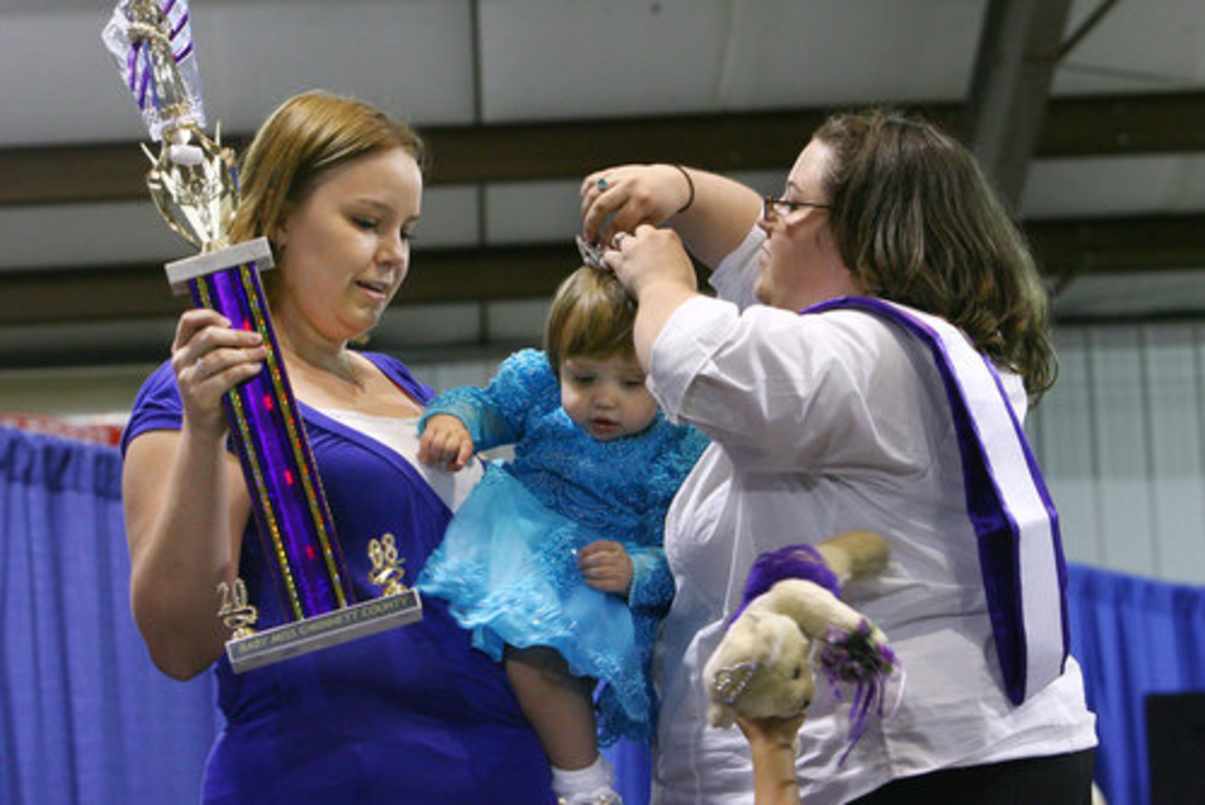 Madilyn Moon is crowned by Samantha Brown of Lawrenceville. Brown is the mother of Jordan Brown, the 2007 Baby Miss Gwinnett.