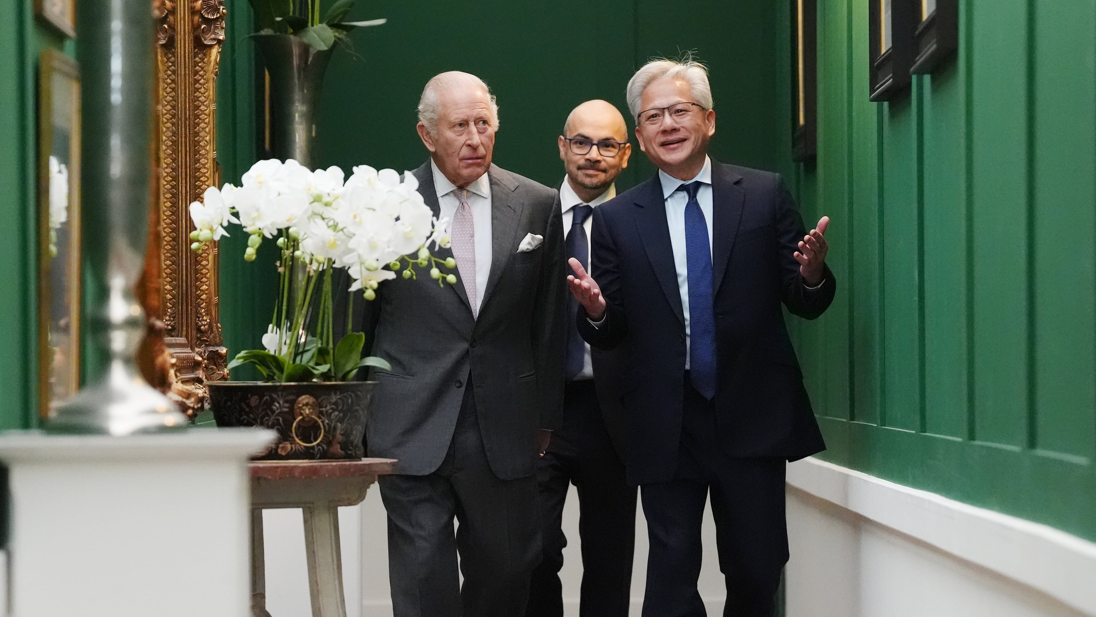 Britain's King Charles III, left, walks with Nvidia chief executive Jensen Huang, right, and Sir Demis Hassabis to a meeting for leaders from the artificial intelligence (AI) sector, government, and thought leaders to discuss how AI can be developed and deployed in ways that benefit society, at Dumfries House in Cumnock, Scotland, Thursday Sept. 17, 2026. (Jonathan Brady/PA via AP, Pool)