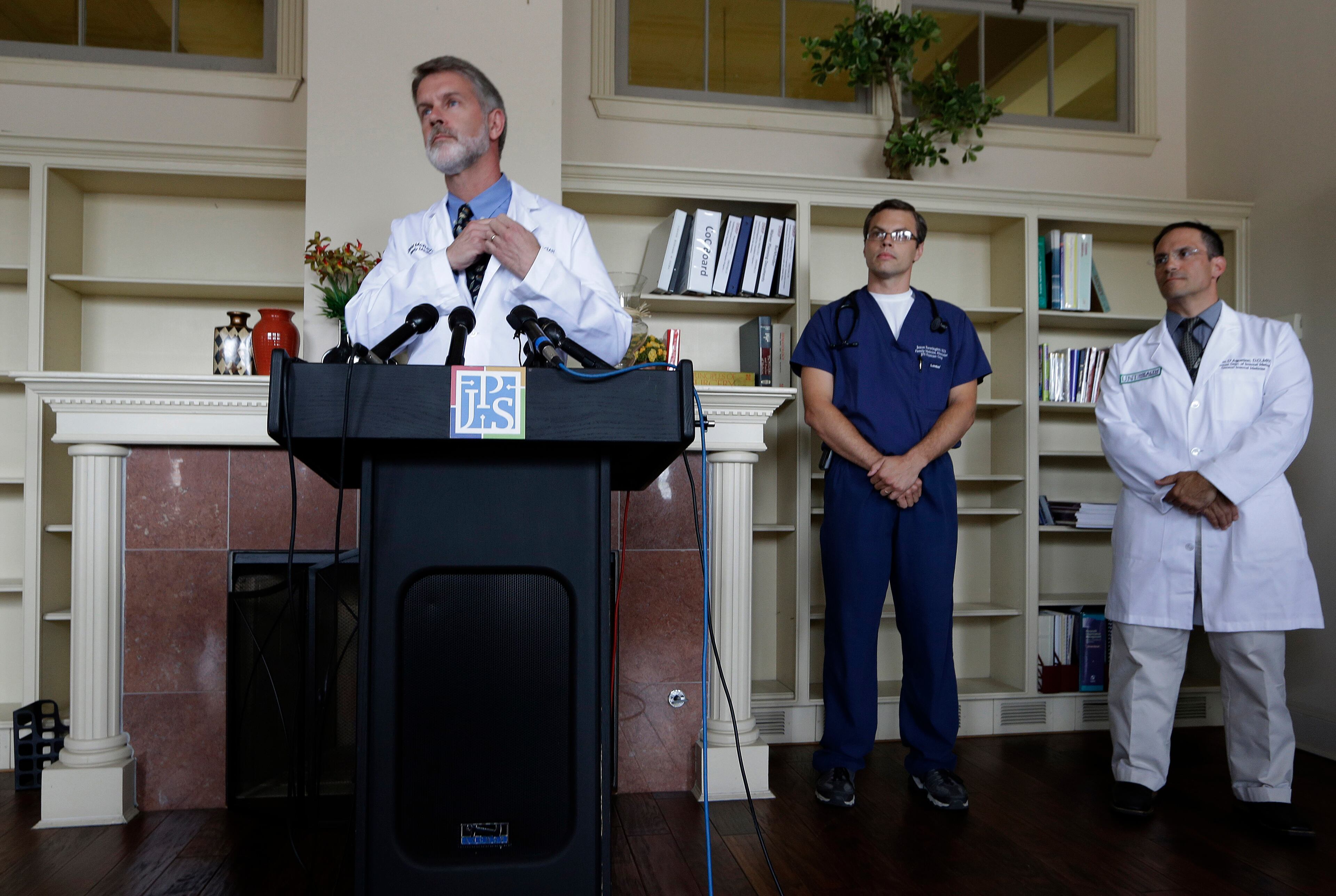 Dr. David Mcray, left, listens to a question during a news conference with Dr. Jason Brewington, center, and Dr. Darrin D'Agostino about fellow doctor Kent Brantly Monday, July 28, 2014, in Fort Worth, Texas. Brantly is one of two American aid workers that have tested positive for the Ebola virus while working to combat an outbreak of the deadly disease at a hospital in Liberia. (AP Photo/LM Otero)