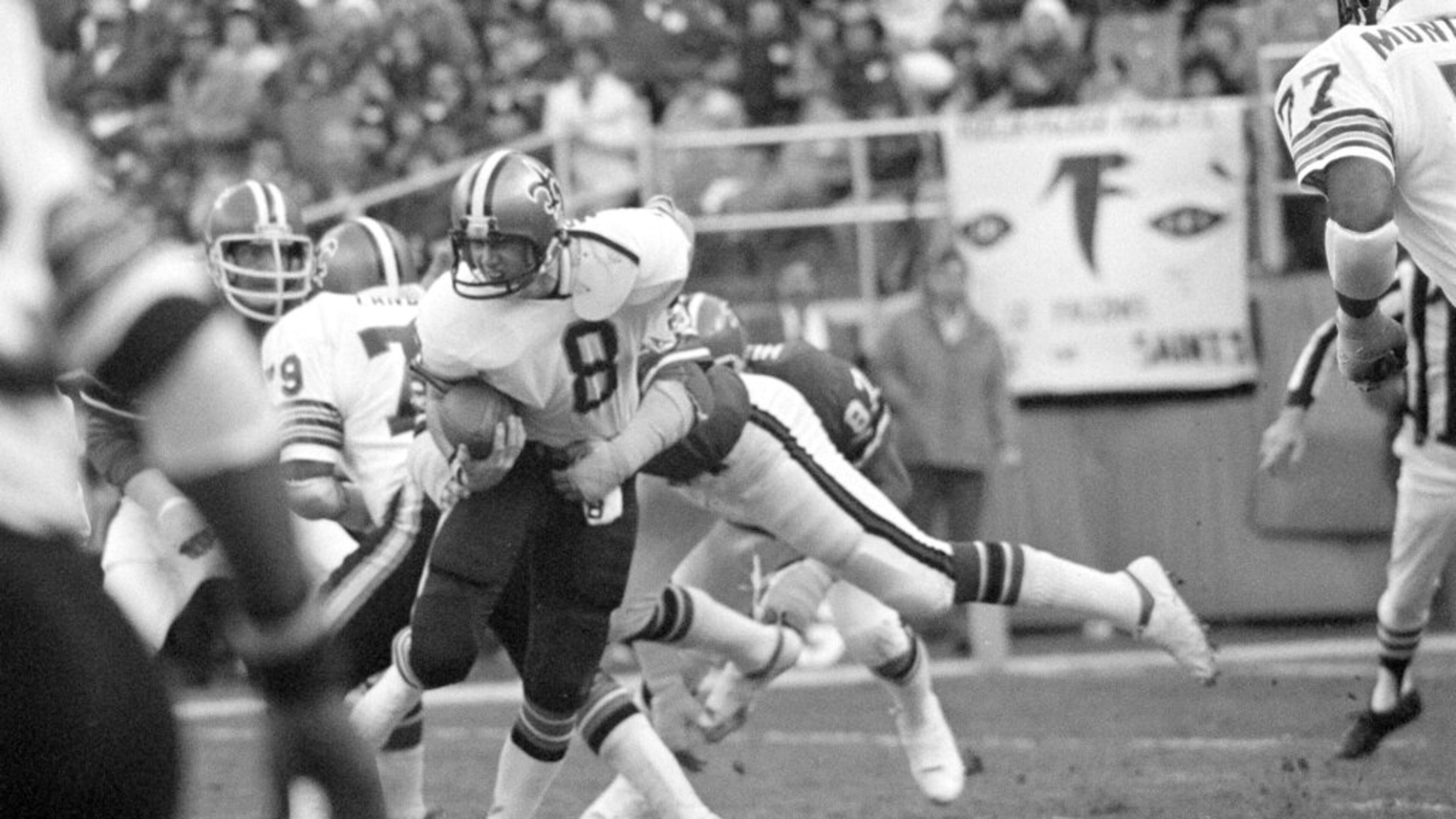 Quarterback Archie Manning (8) of the New Orleans Saints struggles in the clutches of defensive end Claude Humphrey (87) of the Atlanta Falcons in first half action at Atlanta-Fulton County Stadium in Atlanta, Ga., Dec. 18, 1977. Humphrey's tackle dropped Manning near the Saints goal line. (AP Photo/Charles Kelly)