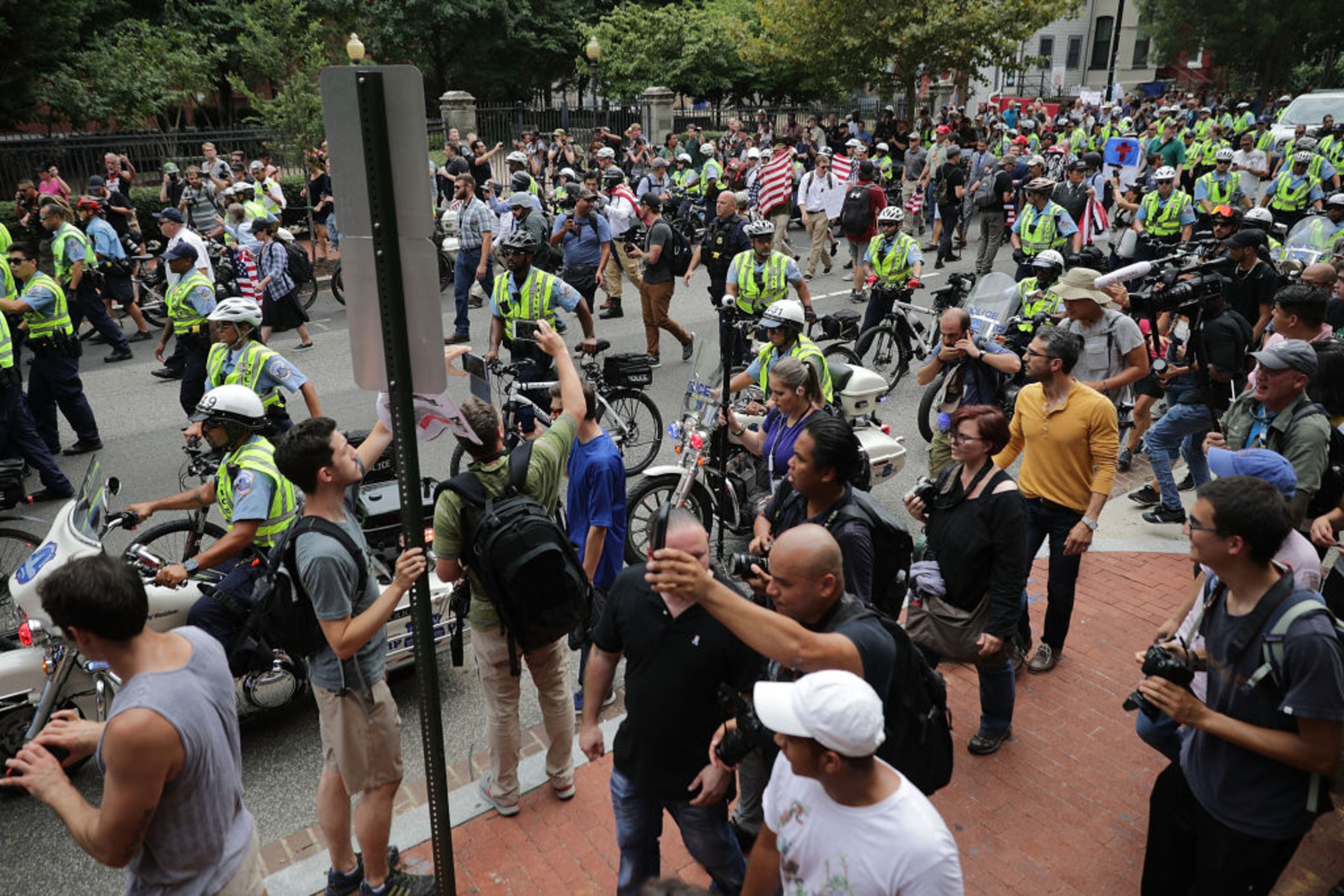 WASHINGTON, DC - AUGUST 12: DC Metro Police form a protective phalanx around participants in the white supremacist Unite the Right rally as they march to White House August 12, 2018 in Washington, DC. Thousands of protesters are expected to demonstrate against the "white civil rights" rally in Washington, which was planned by the organizer of last yearÃs deadly rally in Charlottesville, Virginia. (Photo by Chip Somodevilla/Getty Images)