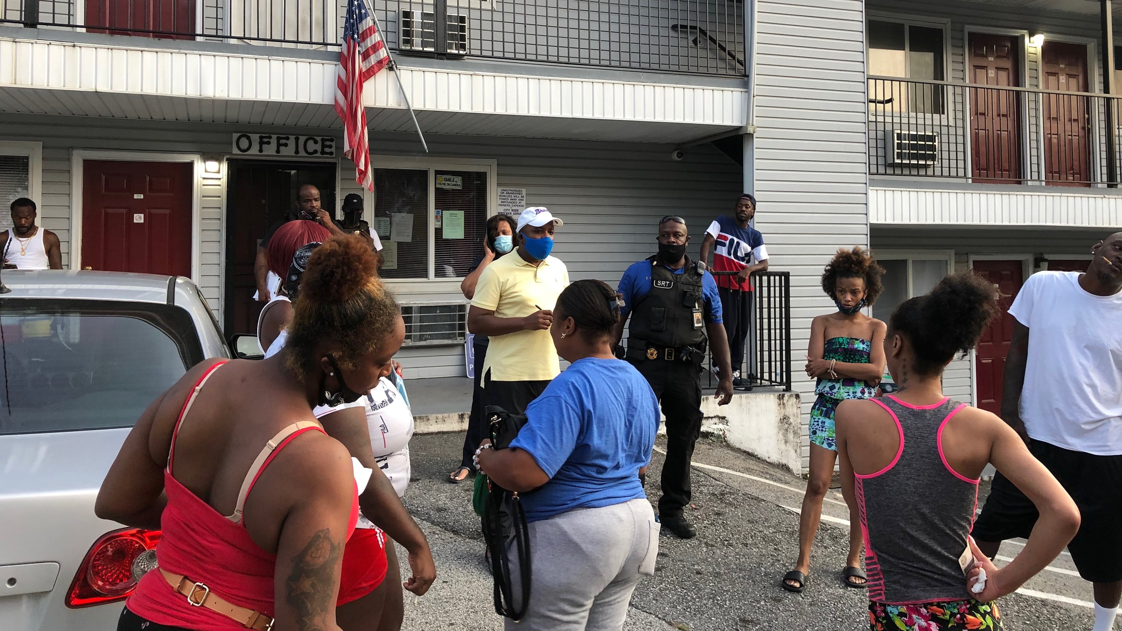 Residents stand outside the Efficiency Lodge in south DeKalb County on Tuesday.