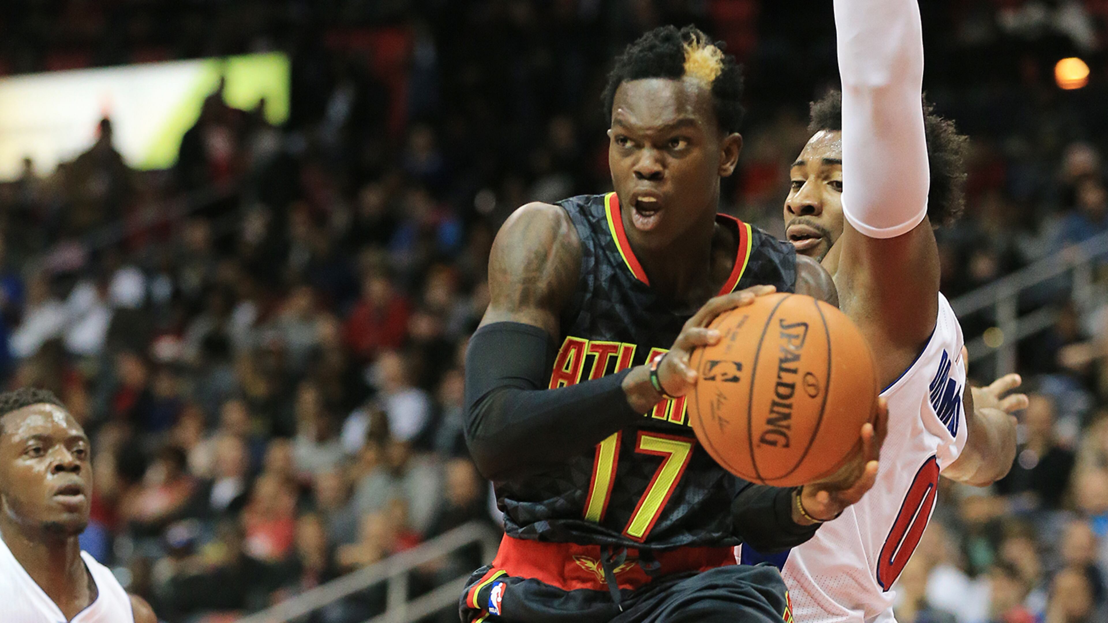 102715 ATLANTA: -- Hawks Dennis Schroder passes off driving the lane against Pistons Andre Drummond during the first period in their first regular season basketball game "home opener" on Tuesday, Oct. 27, 2015, in Atlanta. Curtis Compton / ccompton@ajc.com