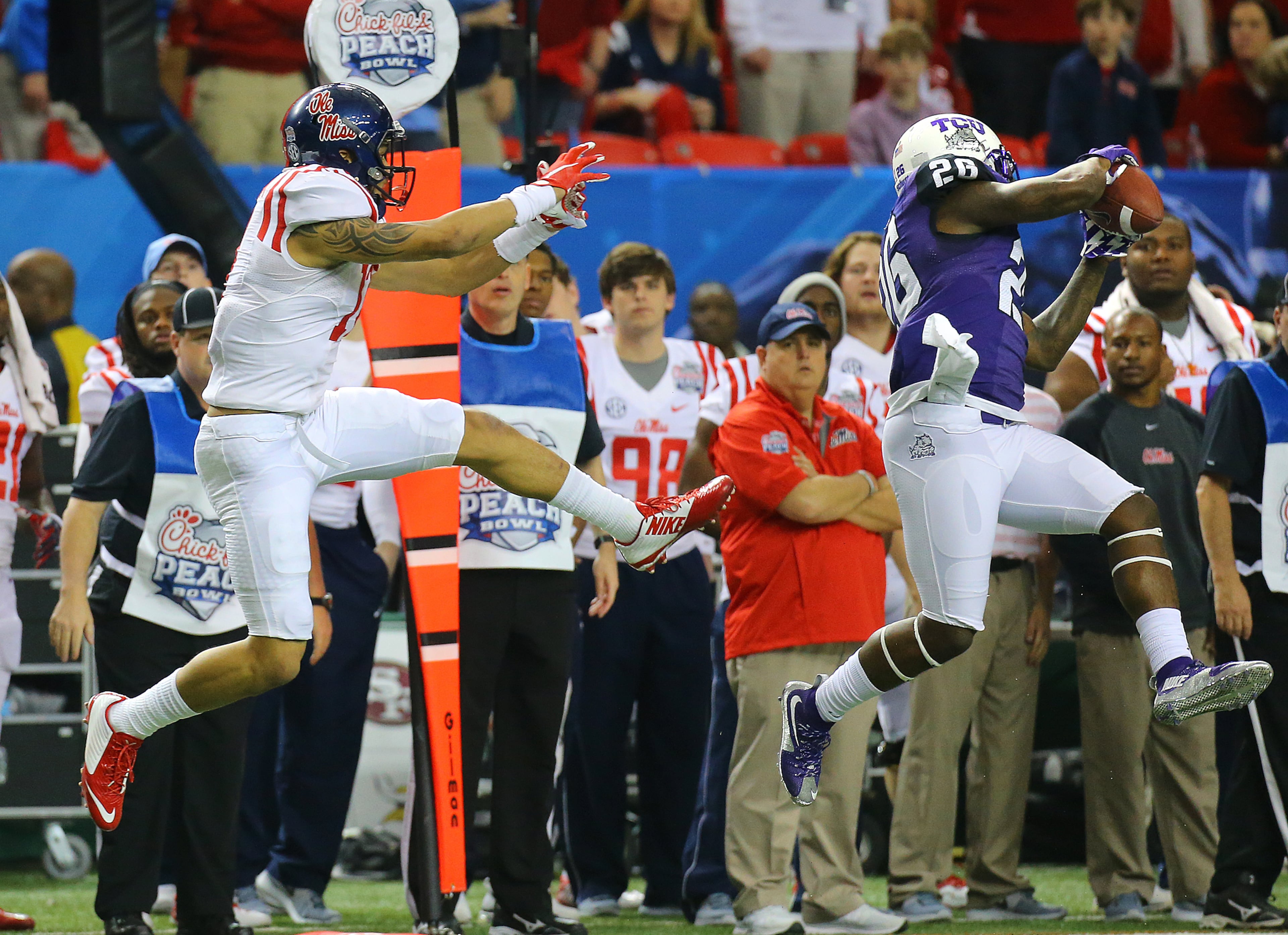 TCU safety Derrick Kindred intercepts a pass intended for Ole Miss tight end Evan Engram during the second half of the Chick-fil-A Peach Bowl on Wednesday, Dec. 31, 2014, in Atlanta. Curtis Compton / ccompton@ajc.com