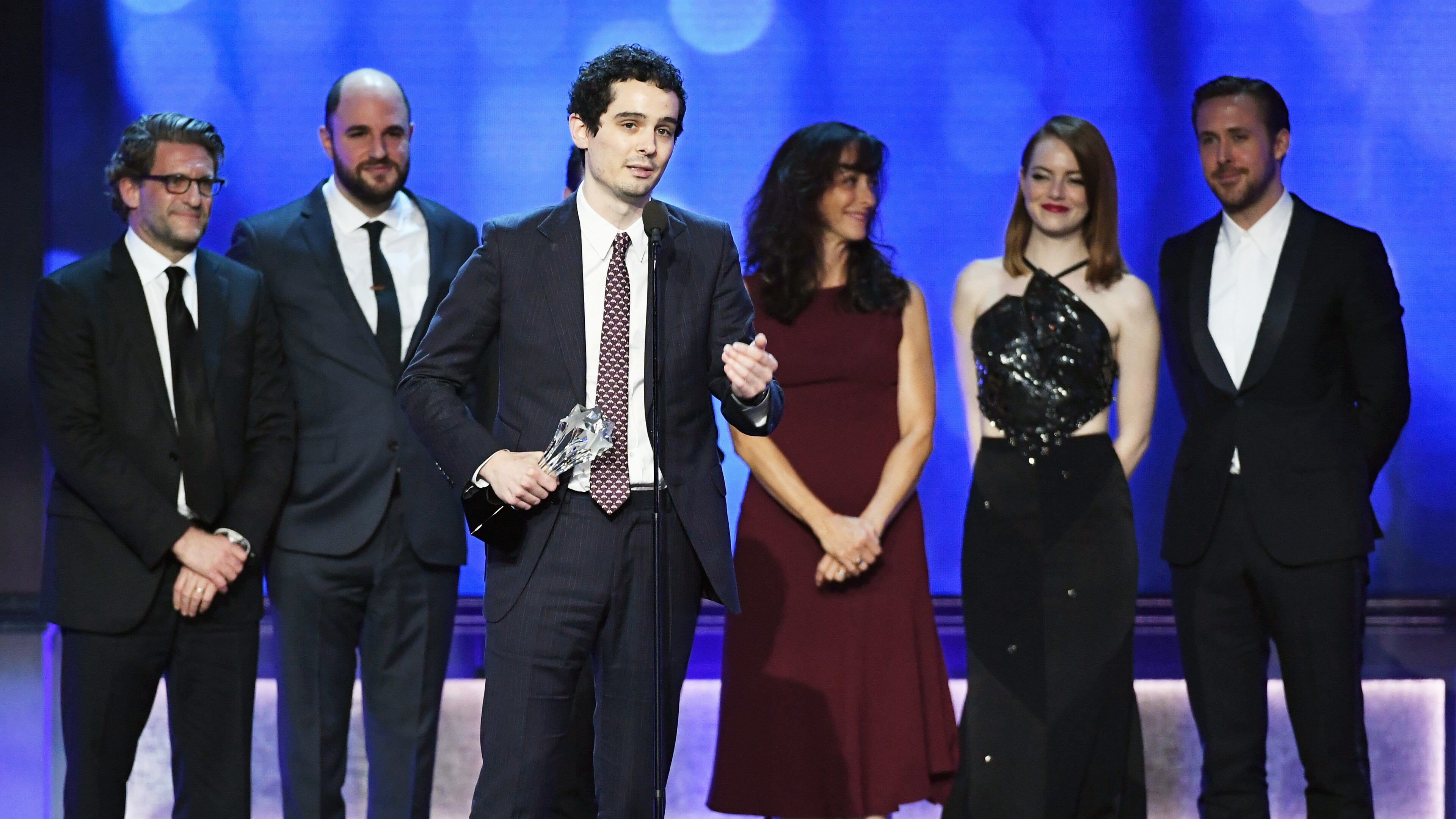 SANTA MONICA, CA - DECEMBER 11: Director Damien Chazelle (C) with producers Gary Gilbert and Jordan Horowitz, composer Justin Hurwitz, costume designer Mary Zophres, actors Emma Stone and Ryan Gosling accept Best Picture for 'La La Land' onstage during the 22nd Annual Critics' Choice Awards at Barker Hangar on December 11, 2016 in Santa Monica, California. (Photo by Ethan Miller/Getty Images)