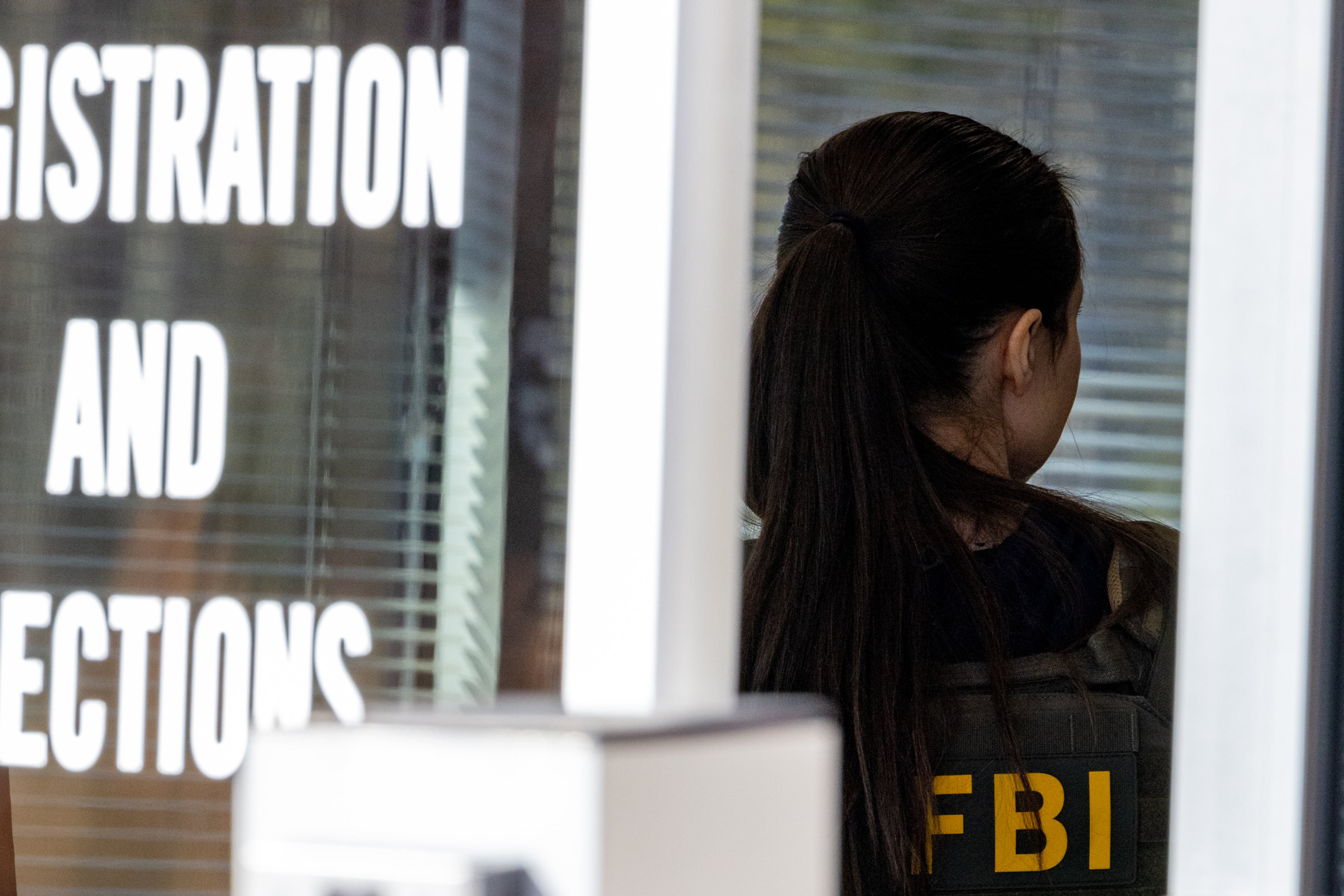 An FBI agent stands inside the entrance to the Fulton County Election Hub and Operation Center in Union City on Wednesday, Jan. 28, 2026. (Arvin Temkar/AJC)