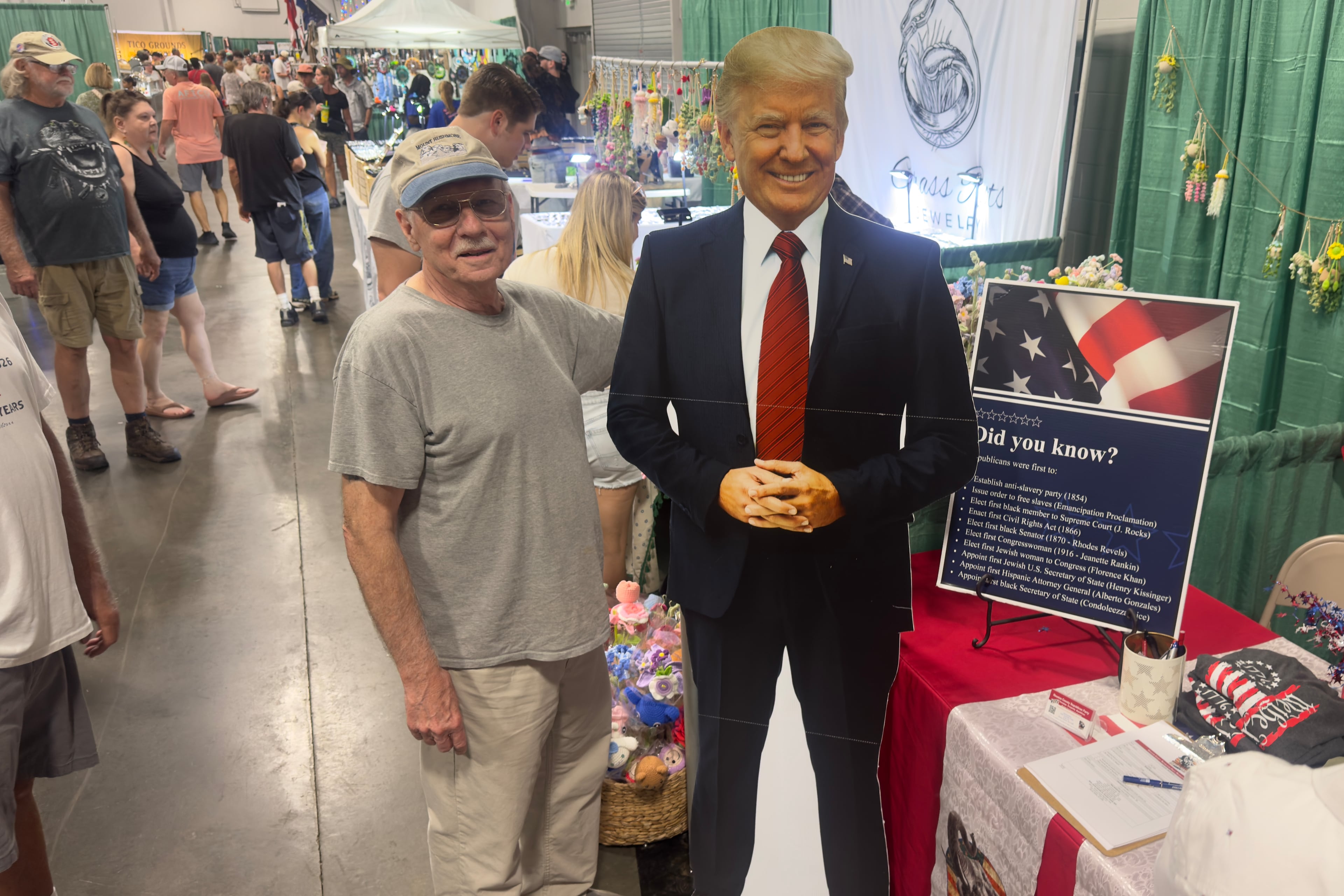 Jerry Mitchell of Covington poses with a cardboard cutout of Donald Trump at a campaign booth run by the Houston County Republican Party at the Georgia National Fair in Perry. (Joe Kovac Jr./AJC)
