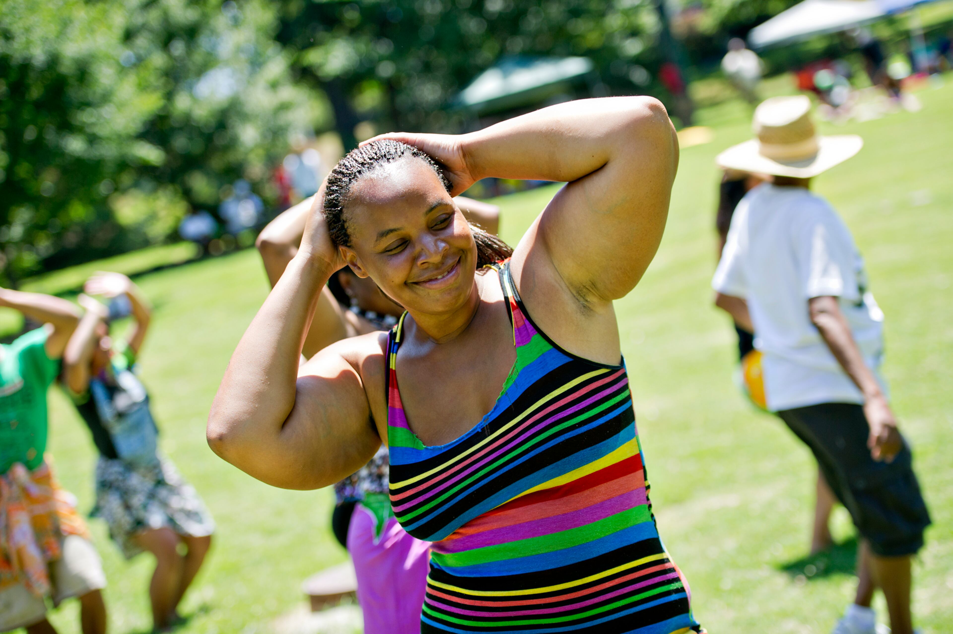 Edna Jeffries (center) learns to hula dance during the Nezian Festival at Grant Park in Atlanta on Saturday, July 5, 2014. The two day festival brought together the culture and traditions of the South Pacific Islands with dance and music performances, food and local merchants.