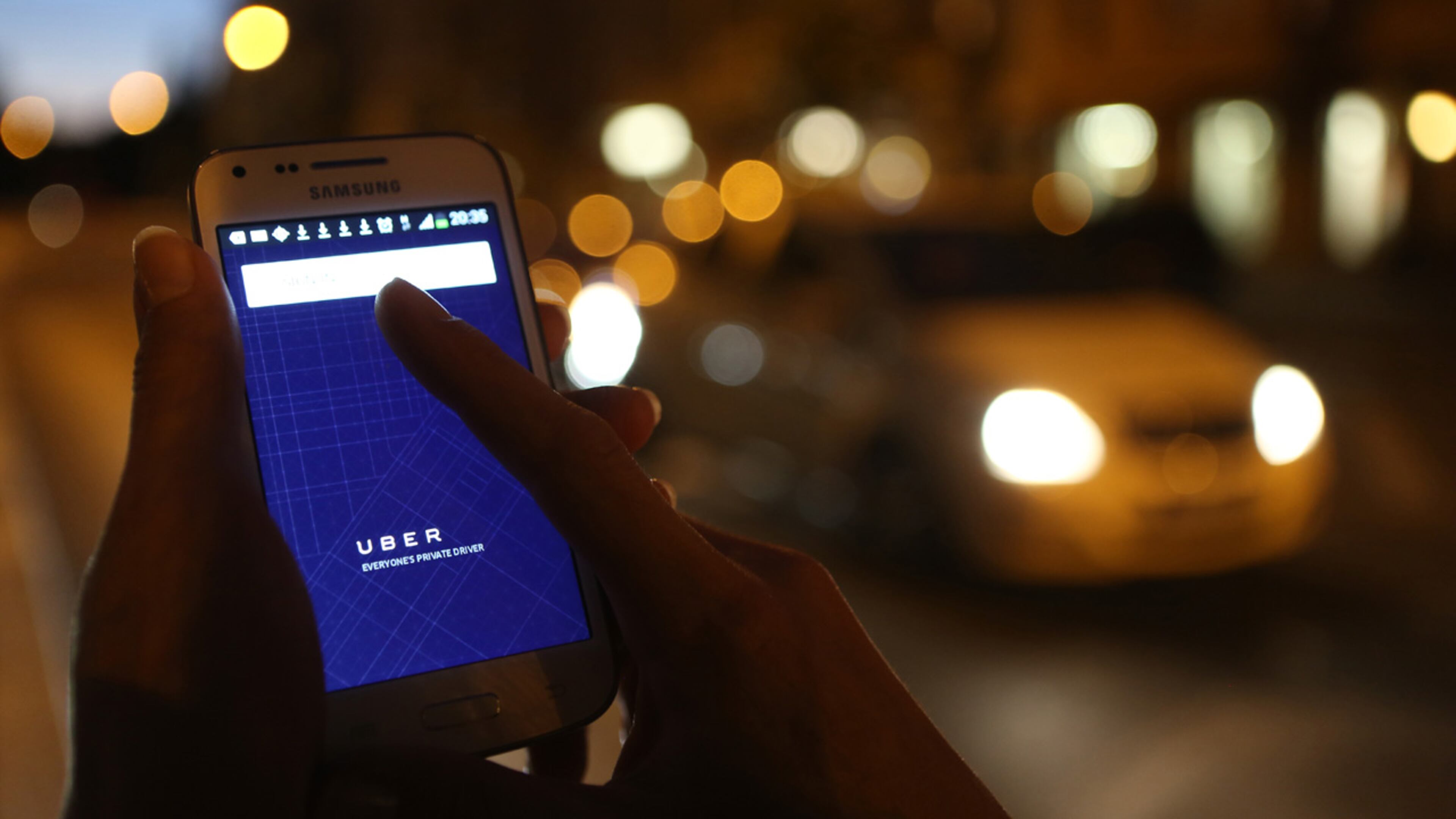In this photo illustration, a woman uses the Uber app on an Samsung smartphone on September 2, 2014 in Berlin, Germany.