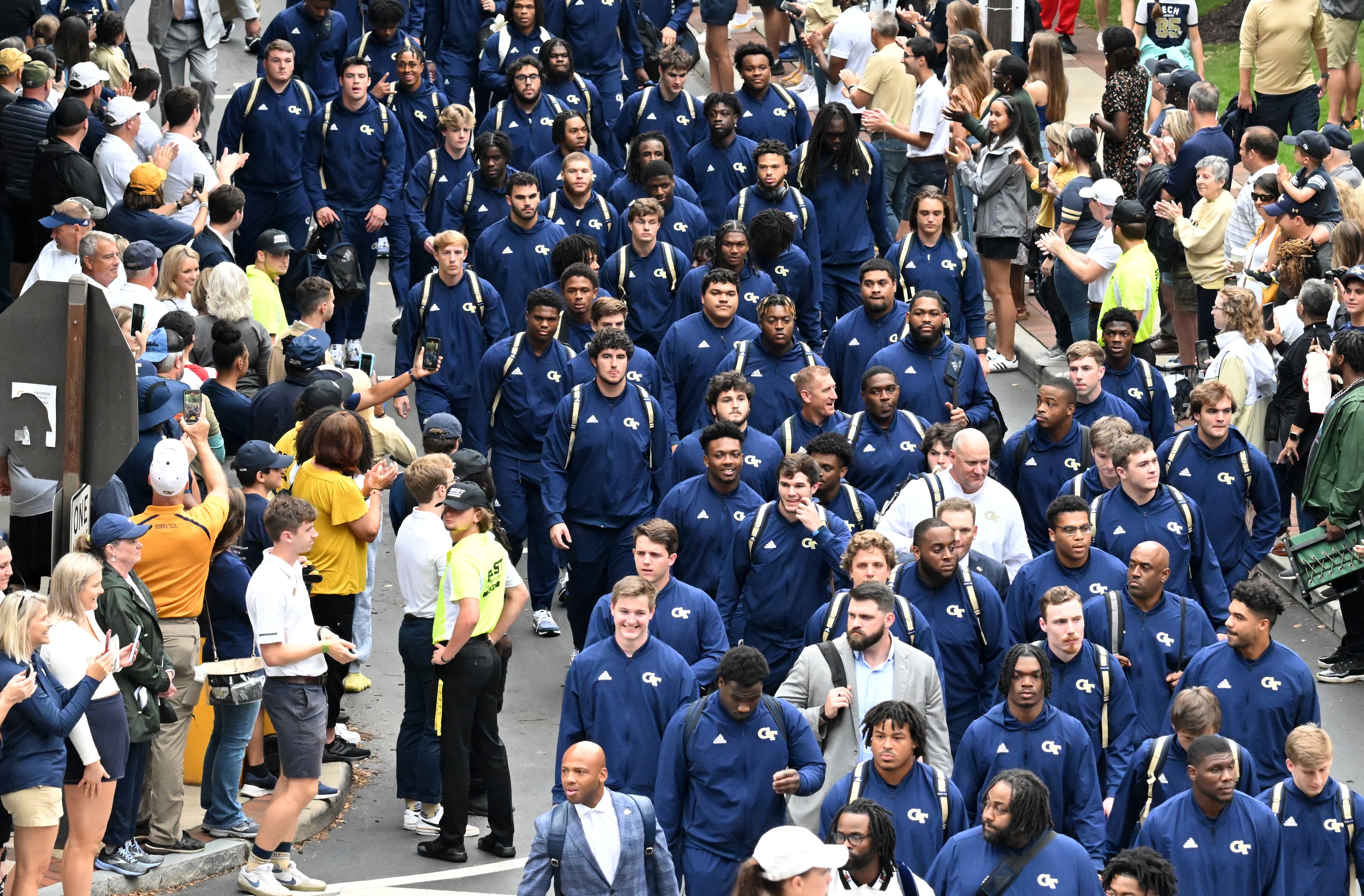 Georgia Tech football players walk Yellow Jacket Alley as they arrive for an NCAA college football game against Western Carolina outside Georgia Tech's Bobby Dodd Stadium in Atlanta on Saturday, September 10, 2022. (Hyosub Shin / Hyosub.Shin@ajc.com)