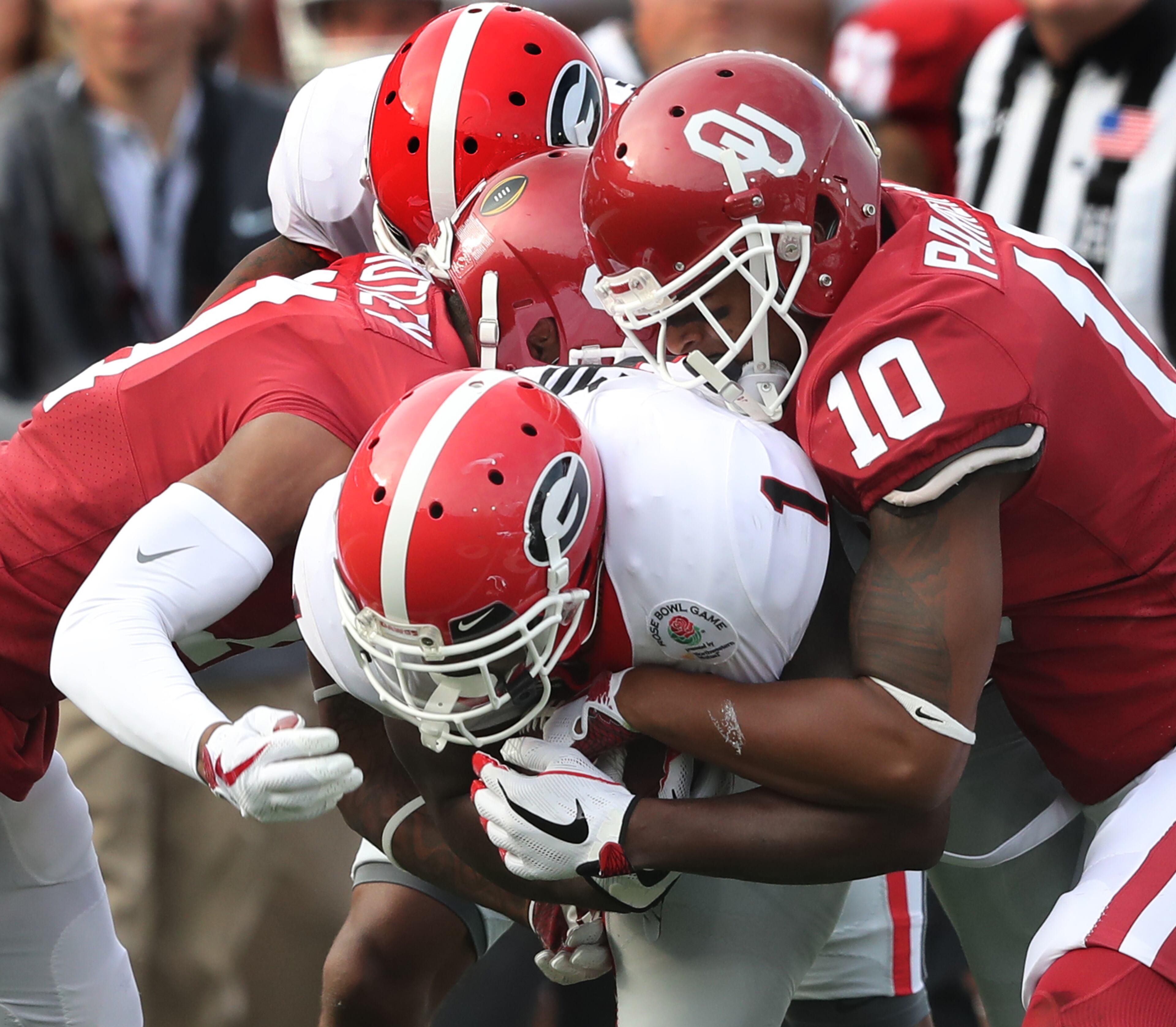 January 1, 2018 Pasadena: Oklahoma defensive back Steven Parker tackles Georgia running back Sony Michel during the first quarter in the College Football Playoff Semifinal at the Rose Bowl Game on Monday, January 1, 2018, in Pasadena. Curtis Compton/ccompton@ajc.com