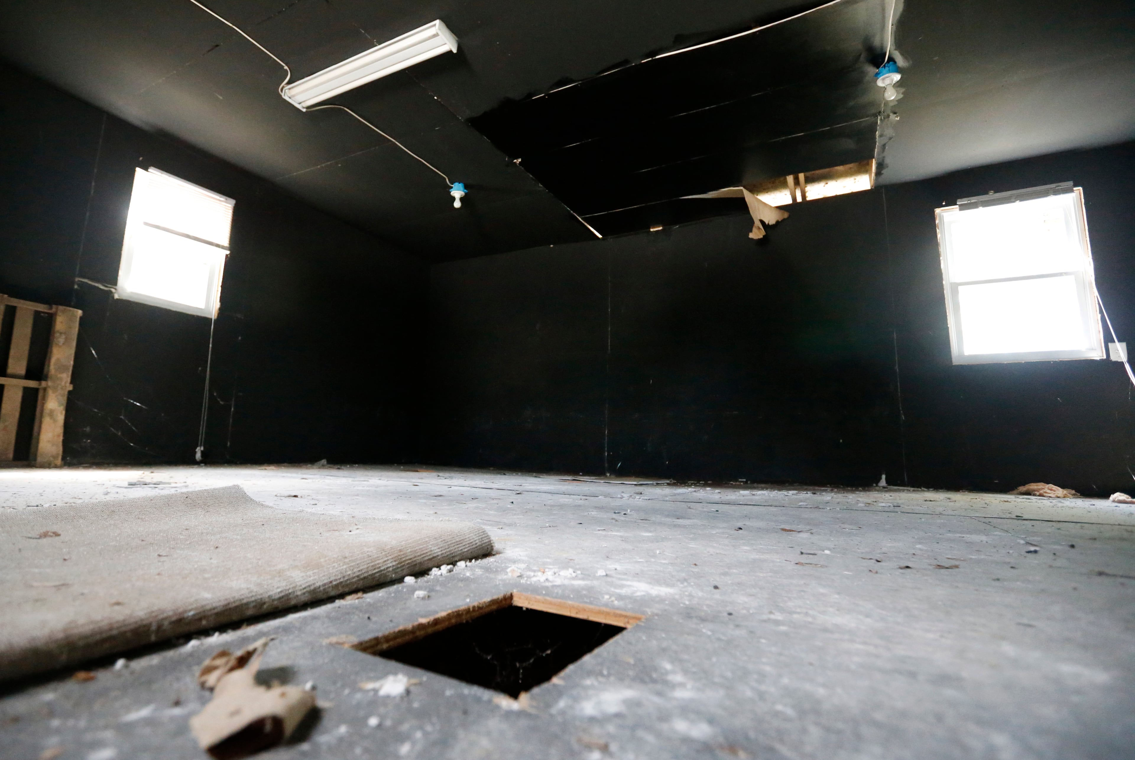 In this June 15, 2015, photo, a hole cut in the floor by investigators in the dog fighting building at the Bad Newz kennel remains during a tour of the Good Newz Rehab Center, the former home of NFL football quarterback Michael Vick in Smithfield, Va. The former Atlanta Falcons star quarterback served an 18-month federal prison sentence for running a dogfighting ring. (AP Photo/Steve Helber)