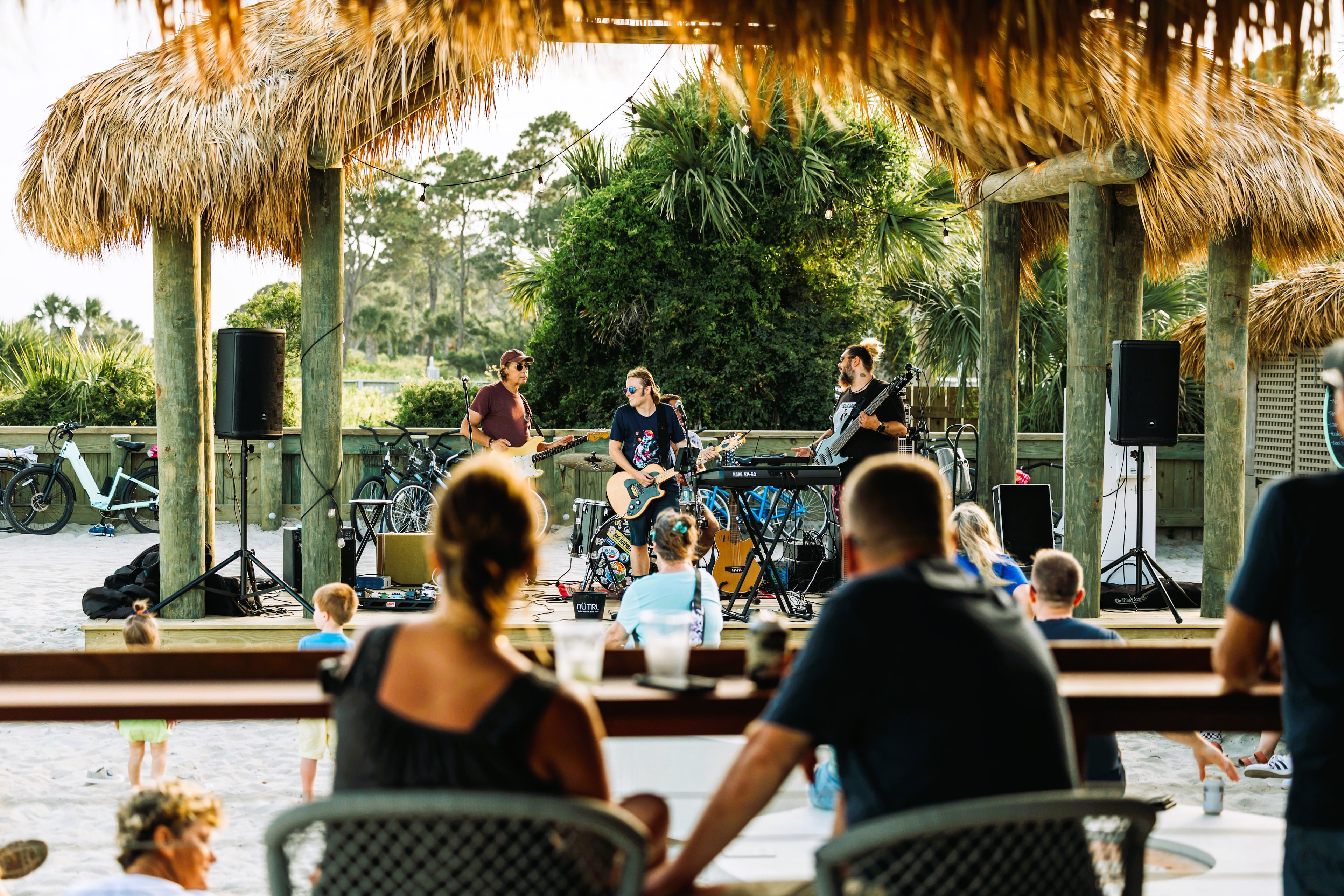 Listen to live music all day and night at the Tiki Hut, a legendary beach bar in front of the Beach House Hilton Head Island resort on Coligny Beach in South Carolina. (Courtesy of Beach House Hilton Head Island)