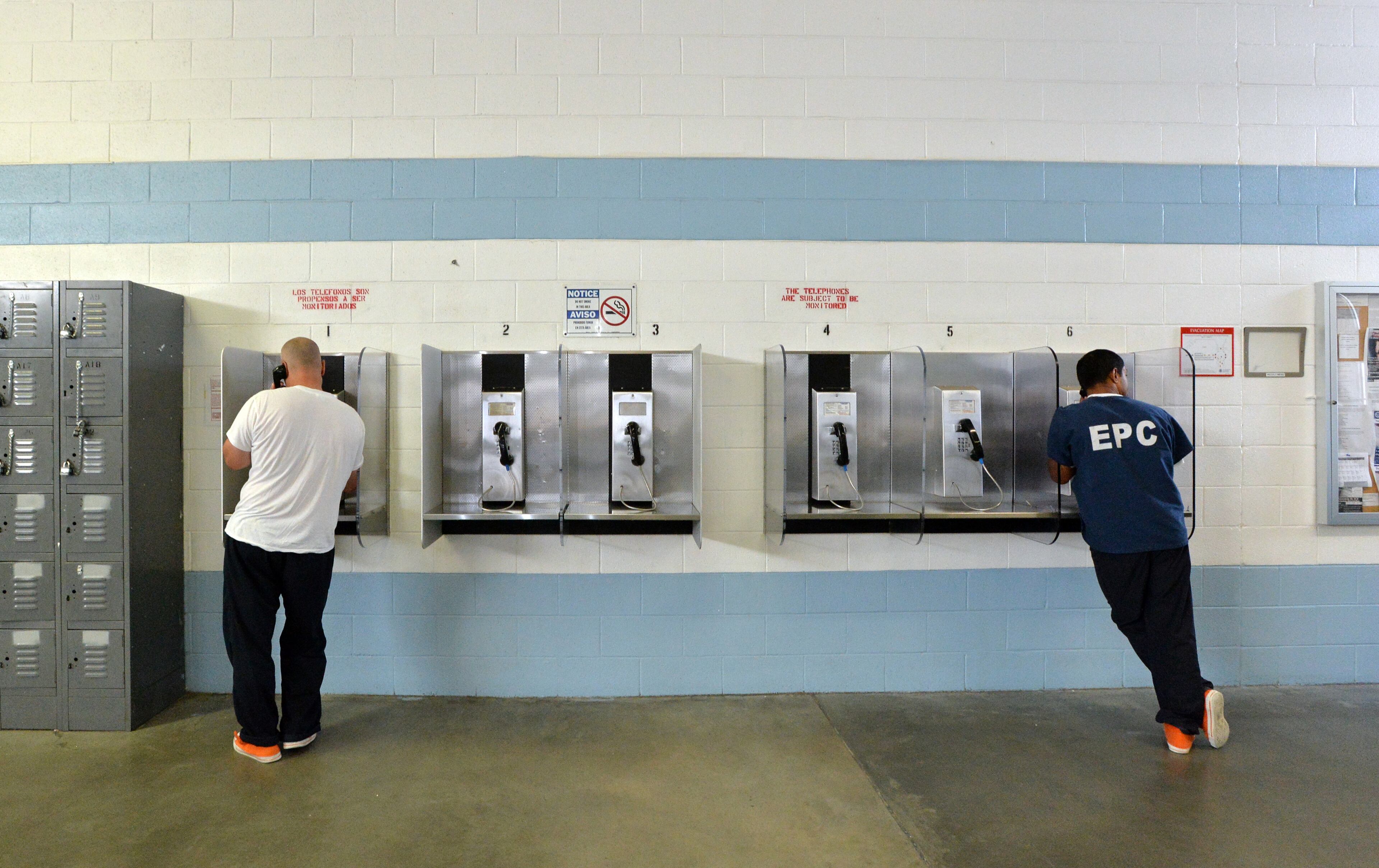 El Paso, Texas - Detainees use a telephone at the El Paso Processing Center in El Paso, Texas on Friday, September 27, 2013. This bustling border city is both a gateway for illegal immigrants and the last stop many see before they are deported. Before they are expelled from the U.S., many illegal immigrants are held at the El Paso Processing Center, a razor wire-rimmed detention facility next to the city airport. HYOSUB SHIN / HSHIN@AJC.COM