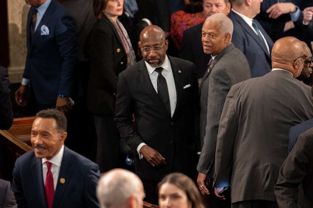 U.S. Sen. Raphael Warnock and U.S. Rep. Hank Johnson, seen here in the U.S. Capitol following then President Joe Biden's state of the union address in 2024. (Nathan Posner for the AJC)