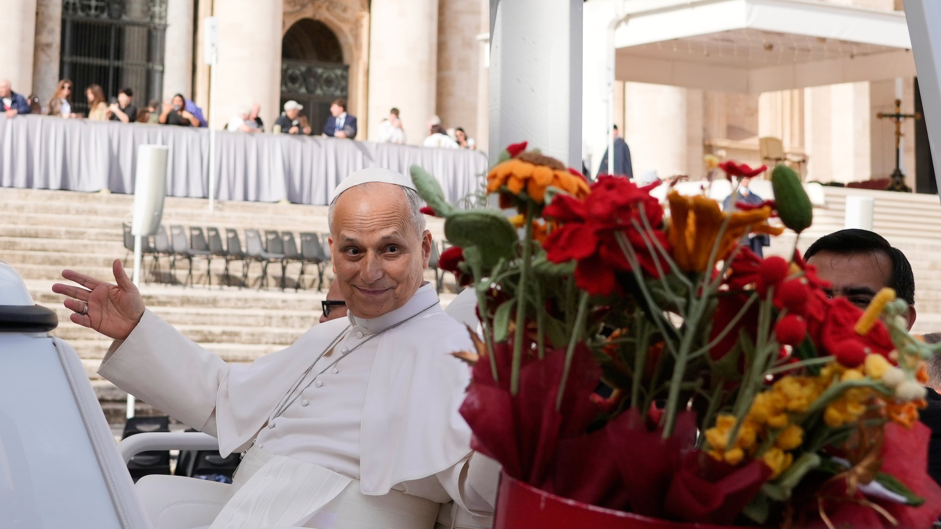Pope Leo XIV is presented with flowers as he leaves at the end of the general audience in St. Peter's Square at The Vatican, Wednesday, Oct. 21, 2026. (AP Photo/Gregorio Borgia)