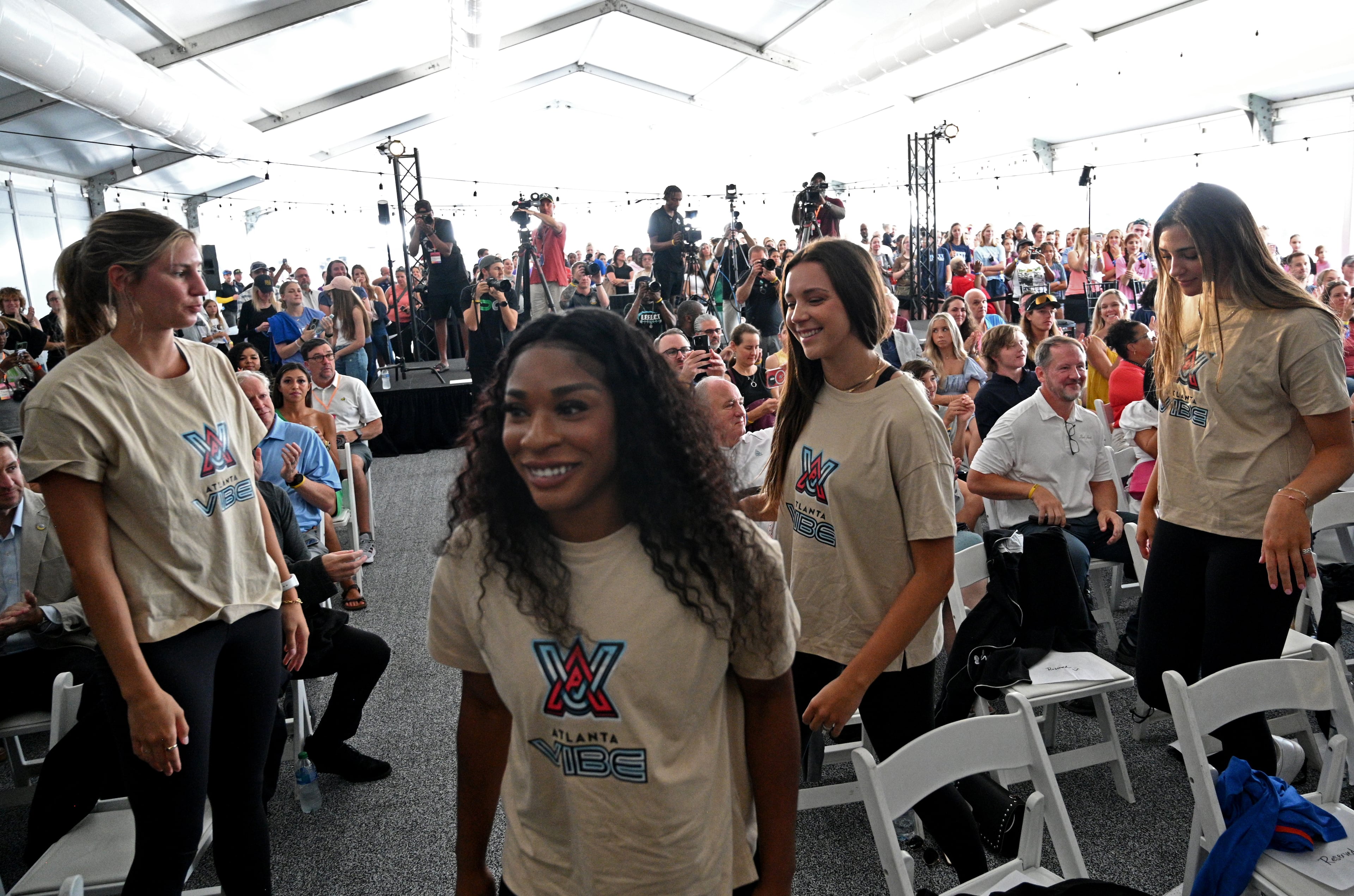 Atlanta Vibe players walk on the stage as the pro volleyball team formally announced its name, colors, and logo on Friday. (Hyosub Shin / Hyosub.Shin@ajc.com)