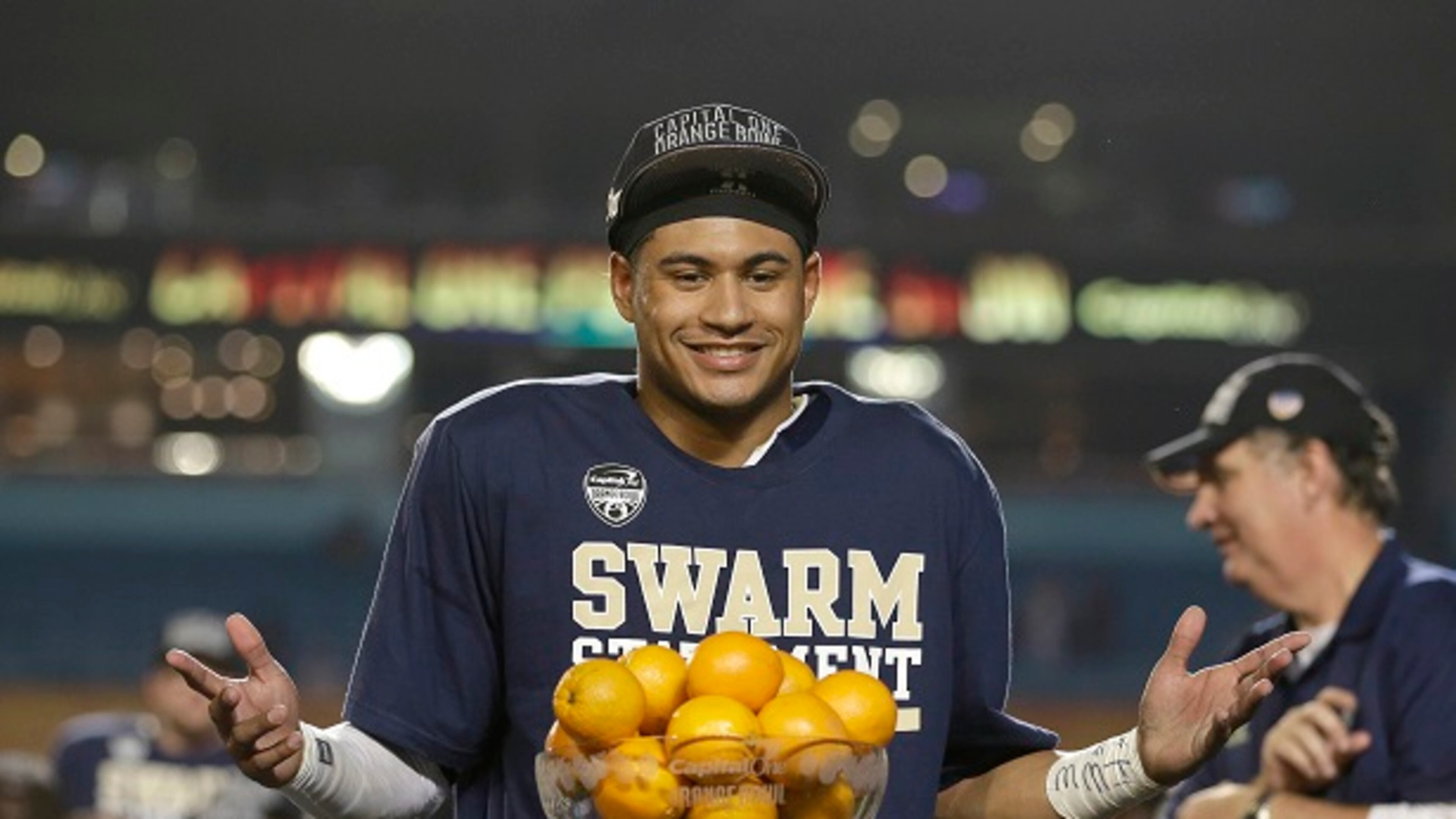 Georgia Tech quarterback Justin Thomas poses with his MVP trophy after the Jackets defeated Mississippi State 49-34 in the Orange Bowl. Coach Paul Johnson is on the right. (AP Photo/Wilfredo Lee, File)