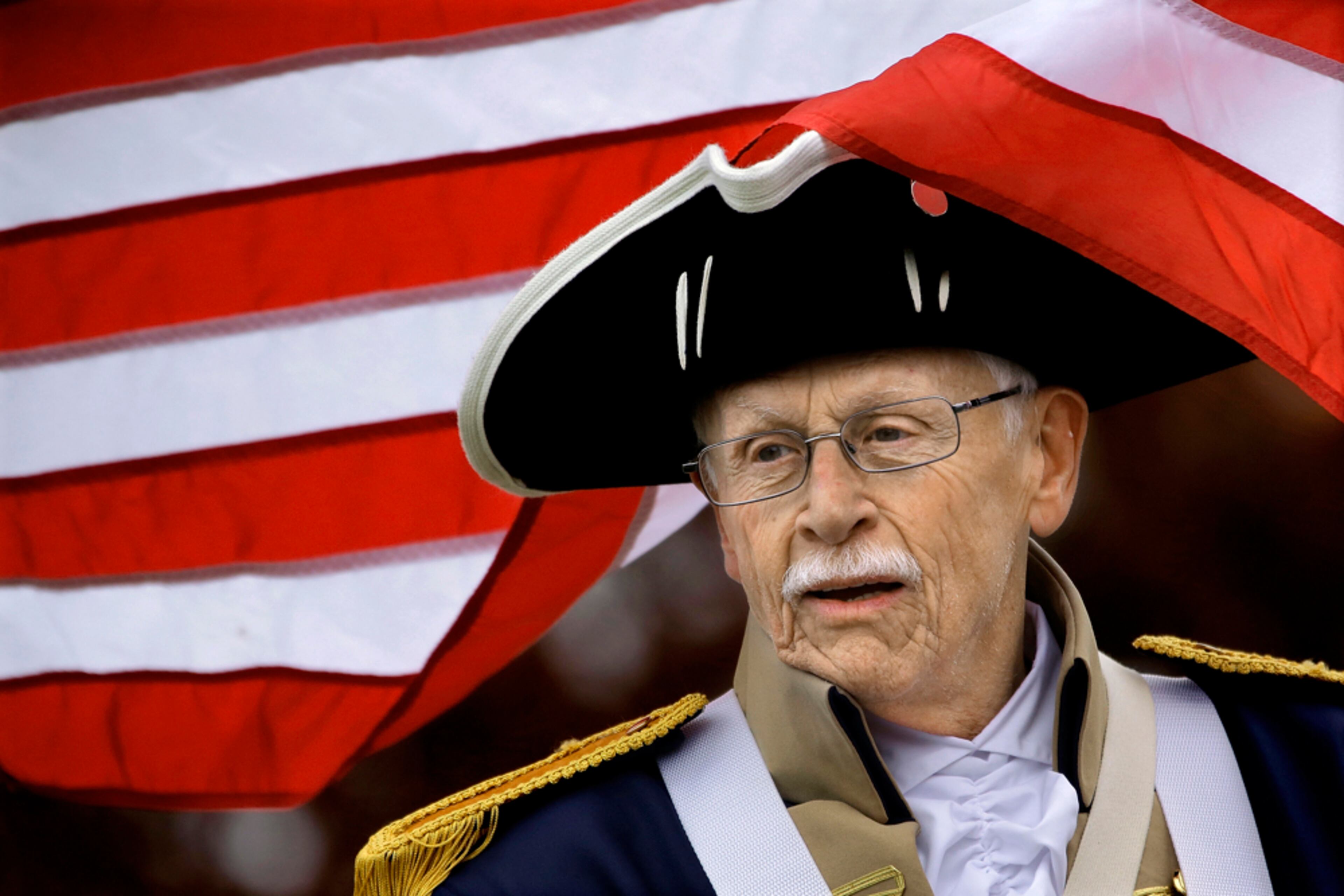 PATRIOT VETERAN--Korean War veteran, Dick Chamblin, from Decatur, Ill., dressed as a Patriot soldier, participates in the Veterans Day ceremonies at Camp Butler National Cemetery. Tuesday, Nov. 11, 2014, in Springfield, Ill. Camp Butler National Cemetery is one of hundreds of cemeteries across the country that are honoring the nation's veterans. (AP Photo/Seth Perlman)