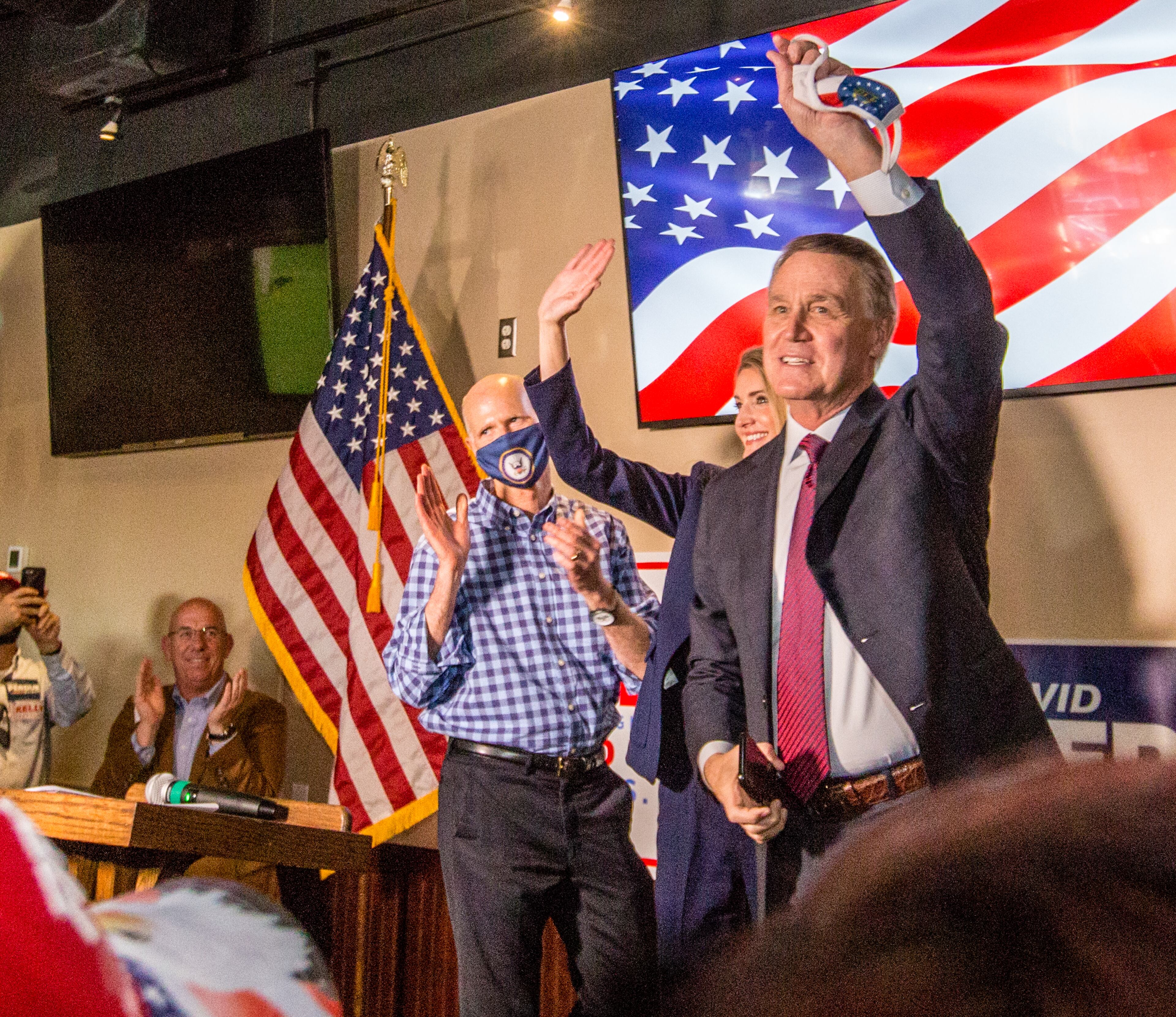 Florida Senator Rick Scott, from left, supports Senators Kelly Loeffler, center, and David Perdue, right, at a rally on Friday, November 13, 2020 at Black Diamond Grill in Cumming, GA. Both Georgia candidates head to a run-off election in January. (Jenni Girtman for The Atlanta Journal Constitution)