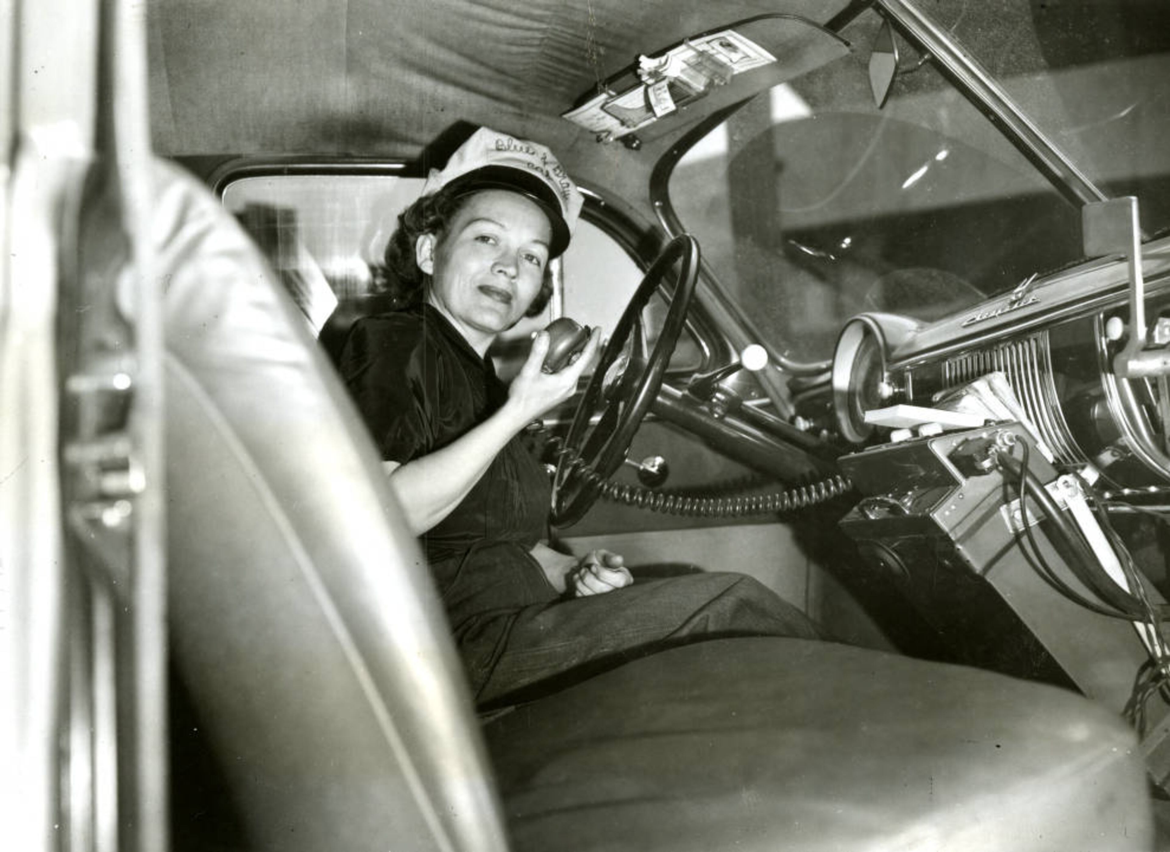 From the original caption: "Demonstrating the cab's two way radio is Mrs. Viola Arnold, who is so small she has to sit on a pillow to see over the wheel. April 8, 1951" AJC file