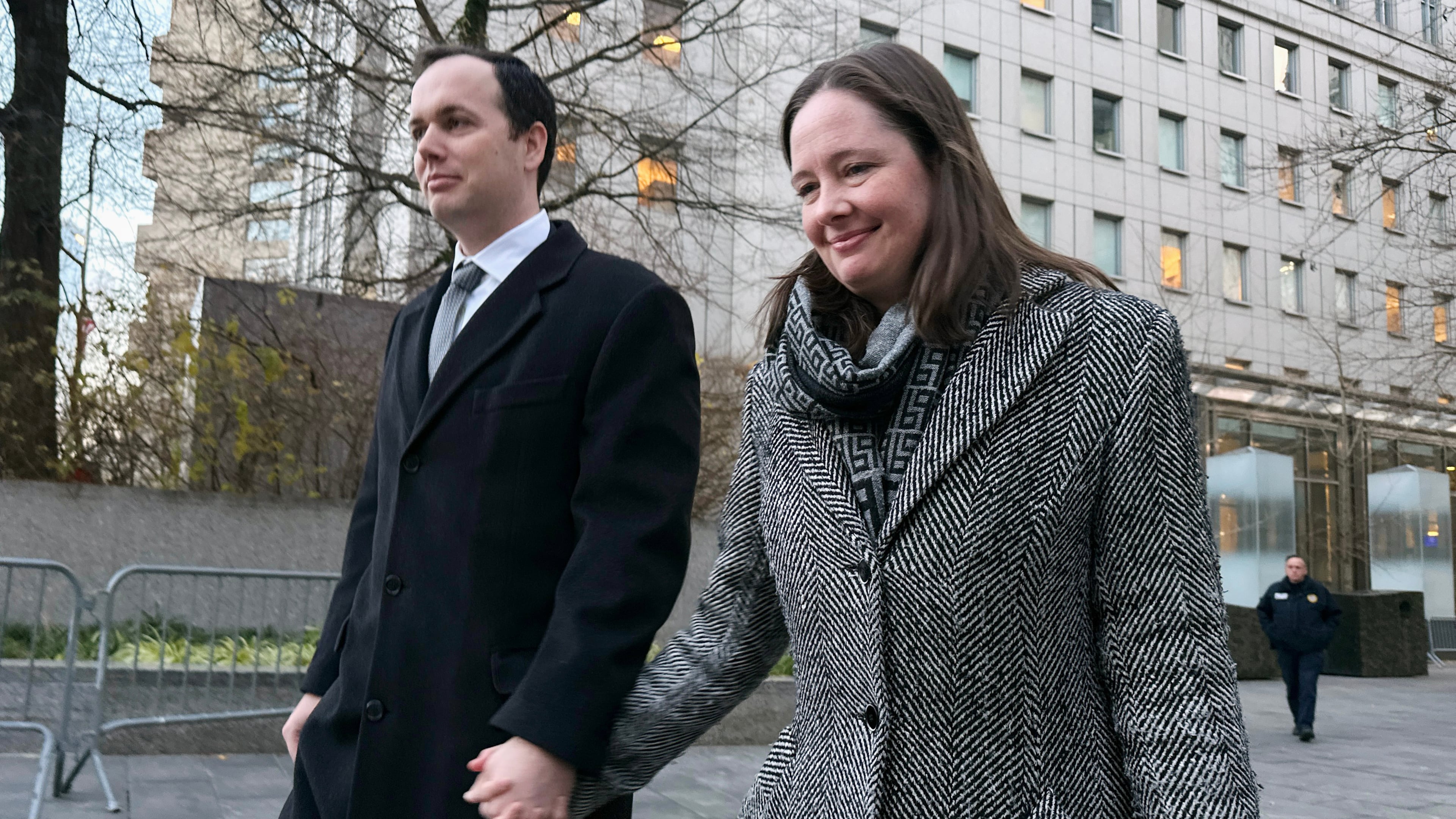 In this photo taken with a smartphone former Assistant U.S. Attorney Maurene Comey and her husband Lucas Issacharoff leave a hearing in her lawsuit over her firing by the Justice Department at a Manhattan federal courthouse on Dec. 4, 2025, in New York. (AP Photo/Michael R. Sisak)