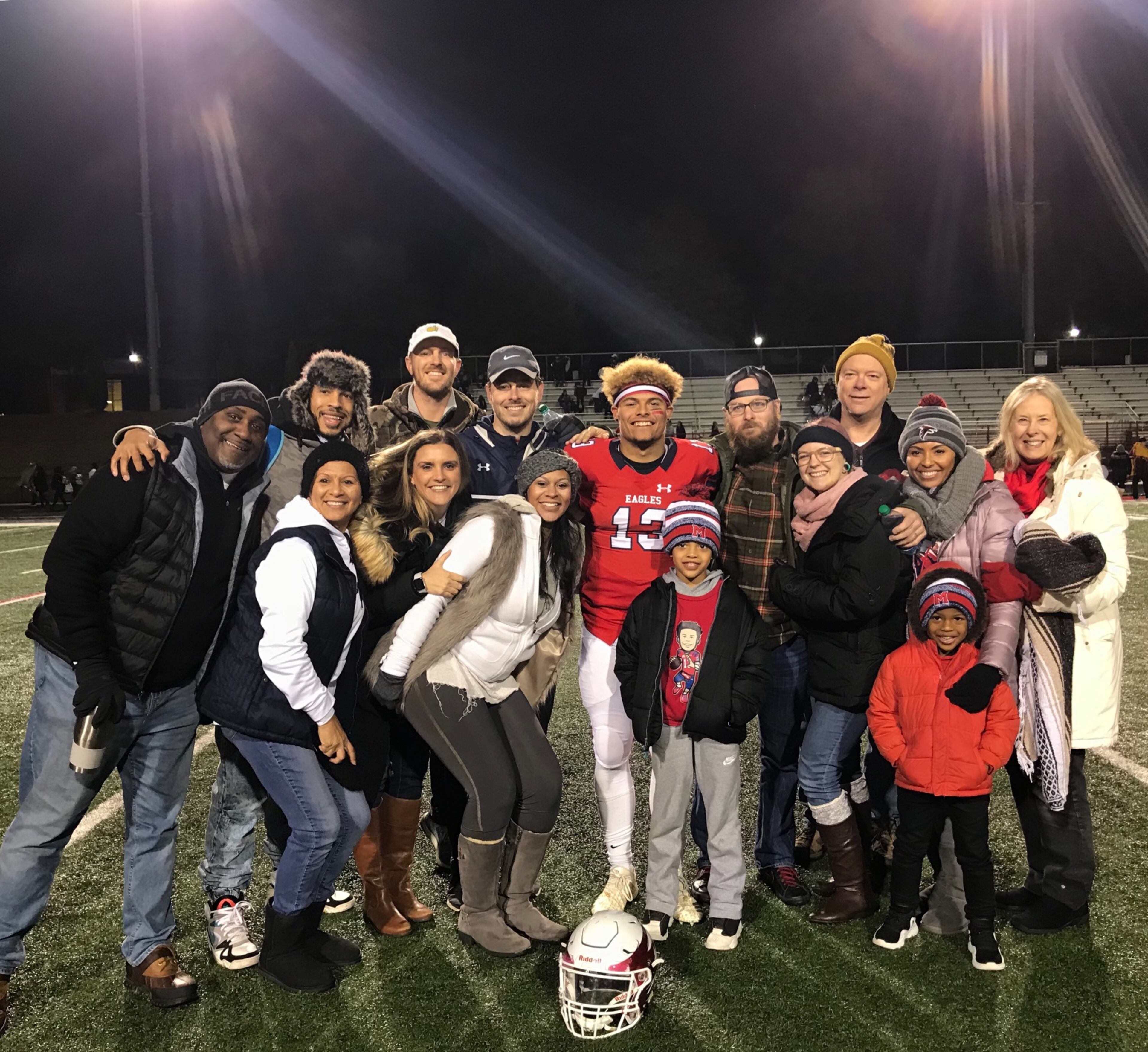 Georgia Tech freshman quarterback Jordan Yates with his family after a game last season at Milton High. In the photo are Jordan's father Evan Yates (to Jordan's immediate right in the Nike cap), stepmother Ashley Yates (white jacket in front of Evan), mother Camille Grayson (in Falcons' winter cap) and stepfather Ray Grayson (in the fur-lined cap on the far left). (Courtesy Evan Yates)