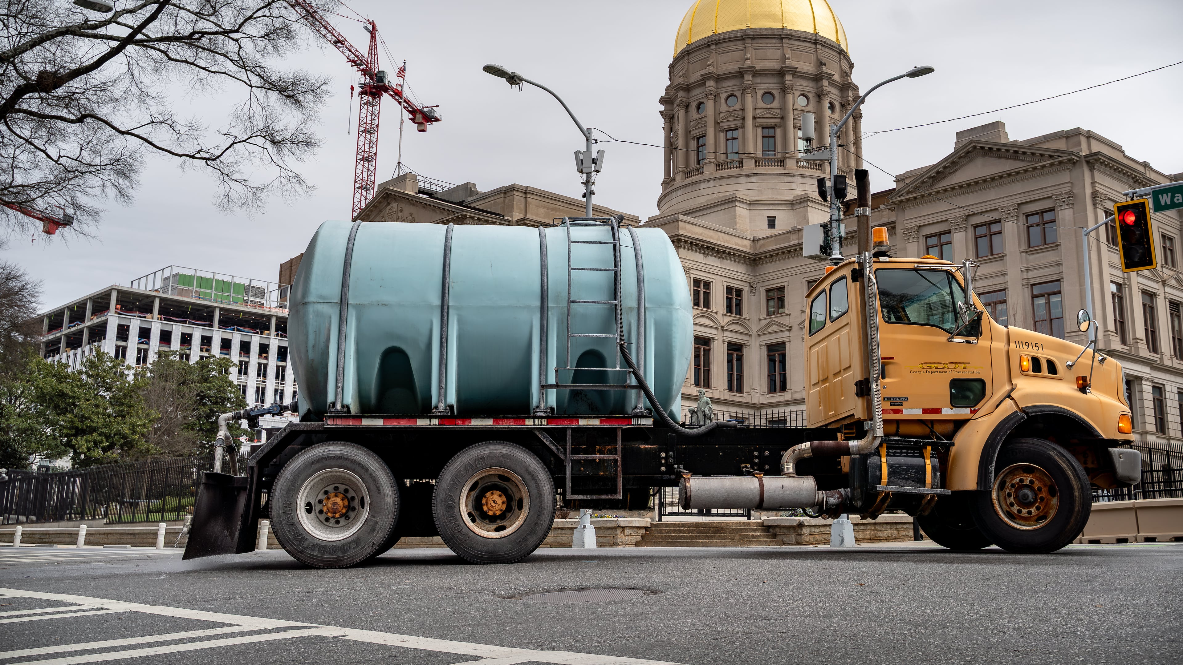 A Georgia Department of Transportation brine truck treats Washington Street outside the Georgia State Capital building. Saturday, Jan 24, 2026 (Ben Hendren for the AJC)