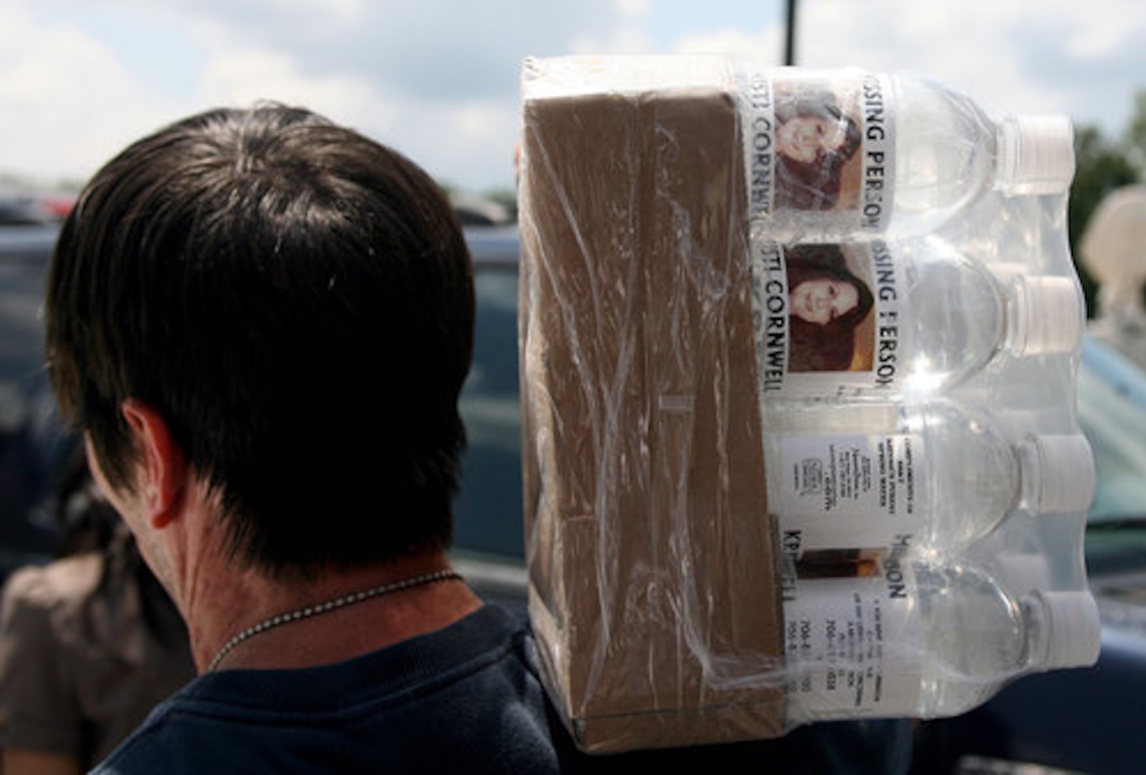 Ryan Patterson delivers water bottles with missing person Kristi Cornwell's photo on it to the Marathon Station off Hwy 515 in Blairsville.