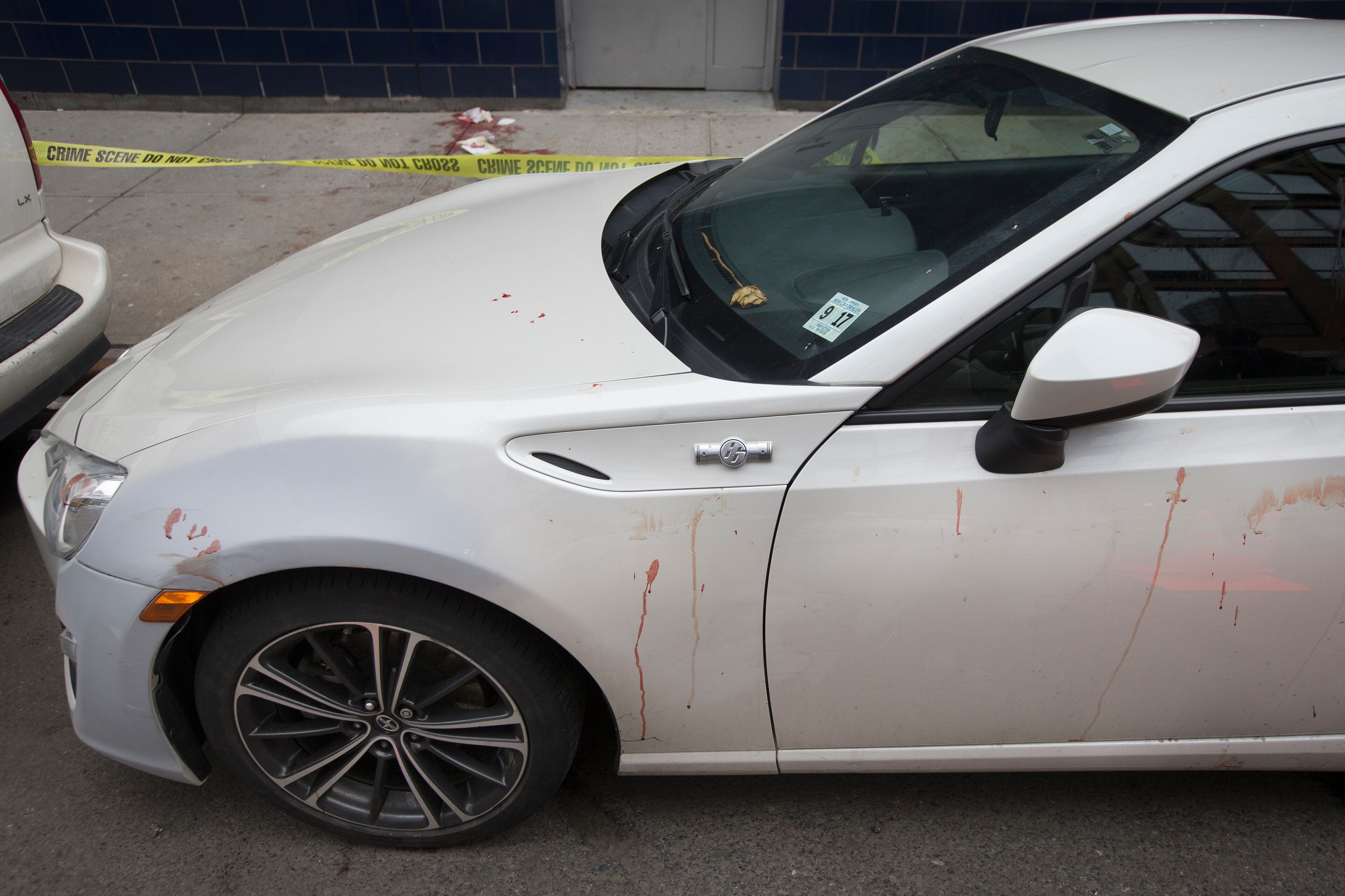 Blood stains a vehicle and pavement near 1 Oak nightclub on West 20th Street, in New York, where authorities say Indiana Pacers forward Chris Copeland, his wife and another woman were stabbed outside after an argument, early Wednesday, April 8, 2015. Police say the victims were hospitalized with minor injuries. (AP Photo/John Minchillo)