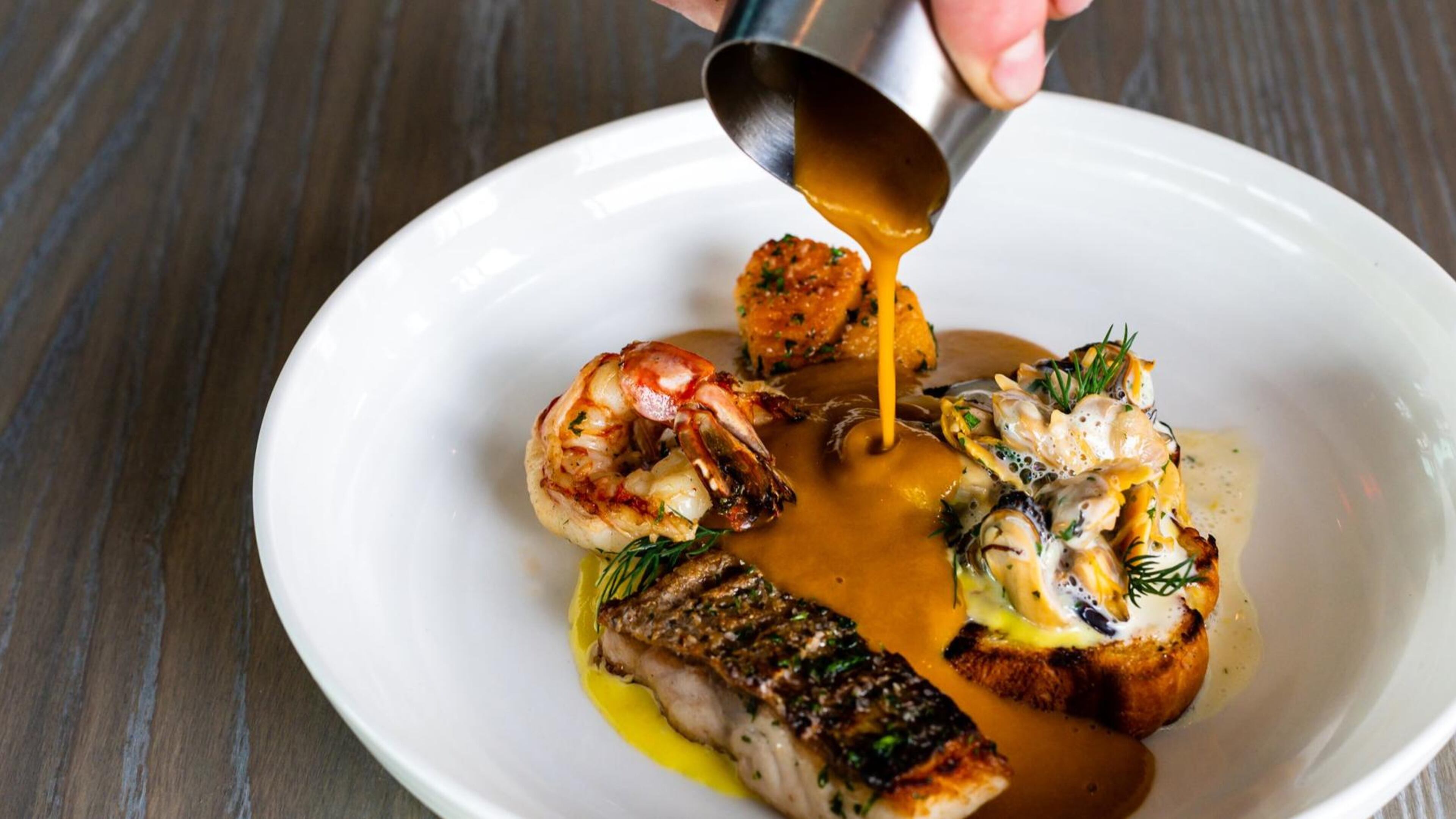 The Aix Bouillabaisse is made with a variety of seafood, but what’s really special is the saffron-tinged broth. CONTRIBUTED BY HENRI HOLLIS