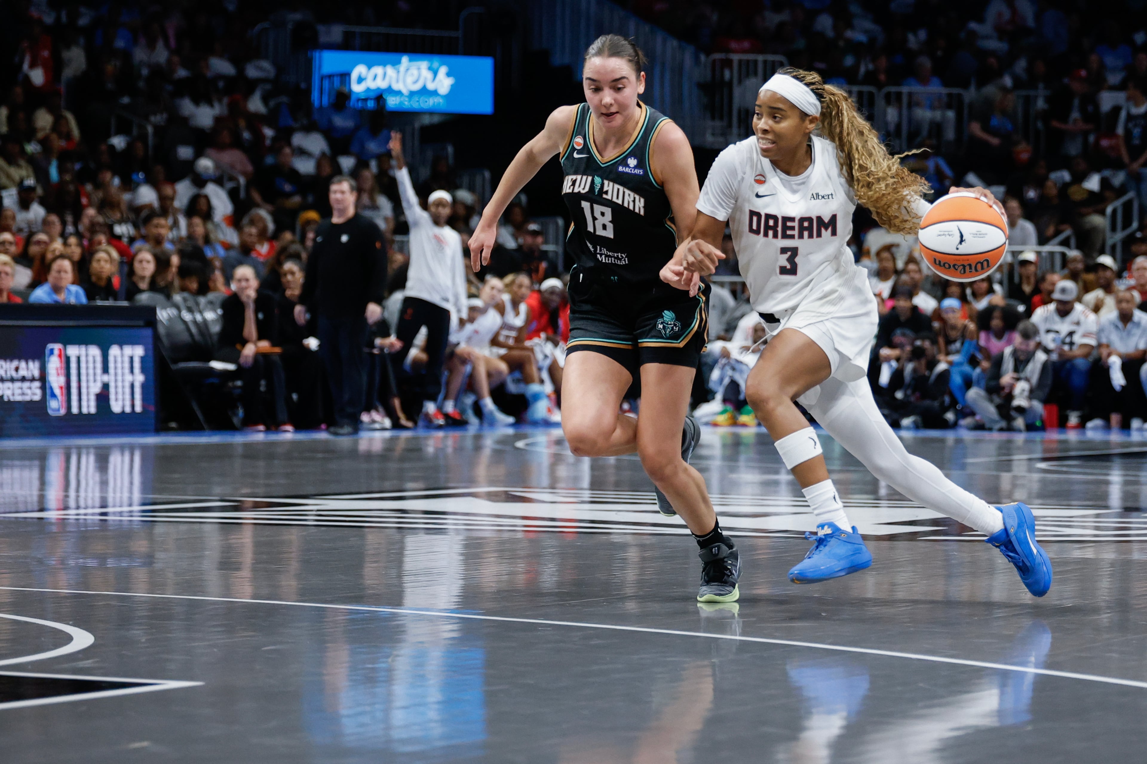 Atlanta Dream guard Jordin Canada (3) drives against New York Liberty guard Pauline Astier (18) during the first half of a WNBA semifinal playoff game 1 between the Atlanta Dream and the New York Liberty, Sunday, Oct. 4, 2026, in Atlanta. (Erik S. Lesser for the AJC)