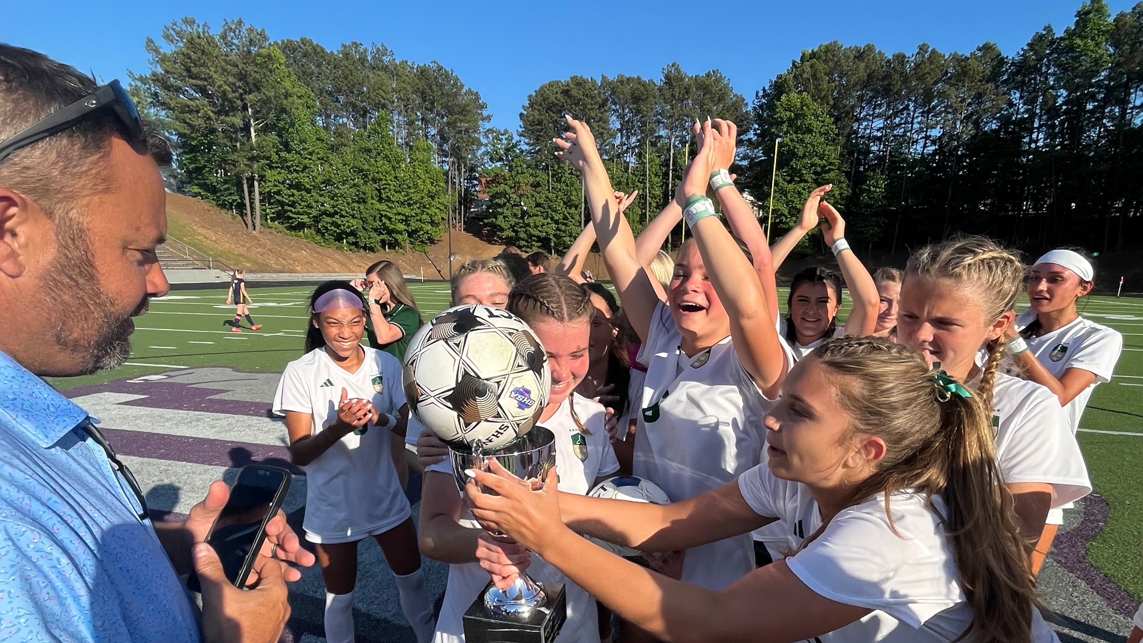 Seniors Amelia Comeaux and Reagan Michals celebrate together after Blessed Trinity beat Marist 1-0 for their second straight state championship. (Staff)