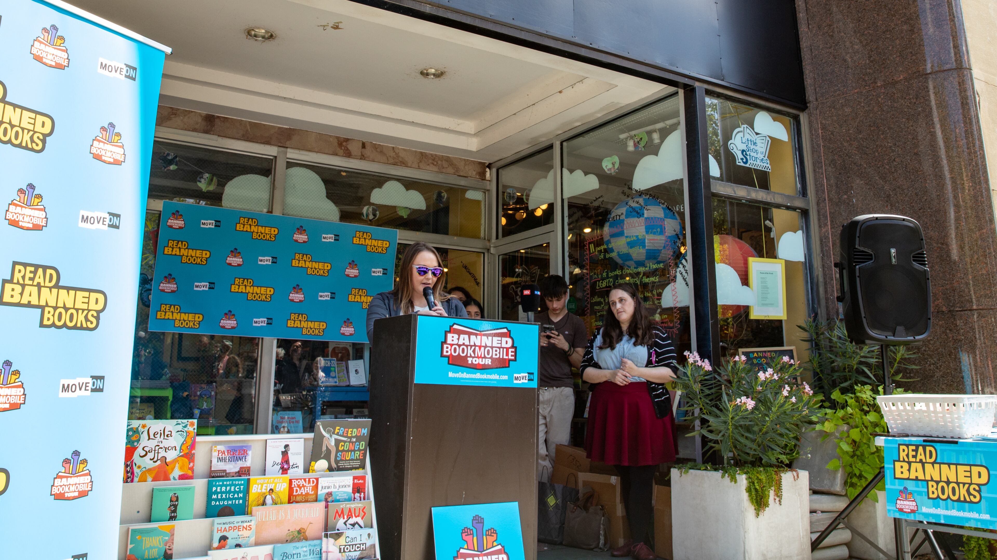 MoveOn Political Action's Banned Bookmobile is distributing free banned books at the kickoff of National Banned Book Week on Sunday, Oct 1, 2023 where speakers, including fired Cobb teacher Katie Rinderle, address concerns around book censorship in school libraries at Little Shop of Stories in Decatur Square. (Jenni Girtman for The Atlanta Journal-Constitution)