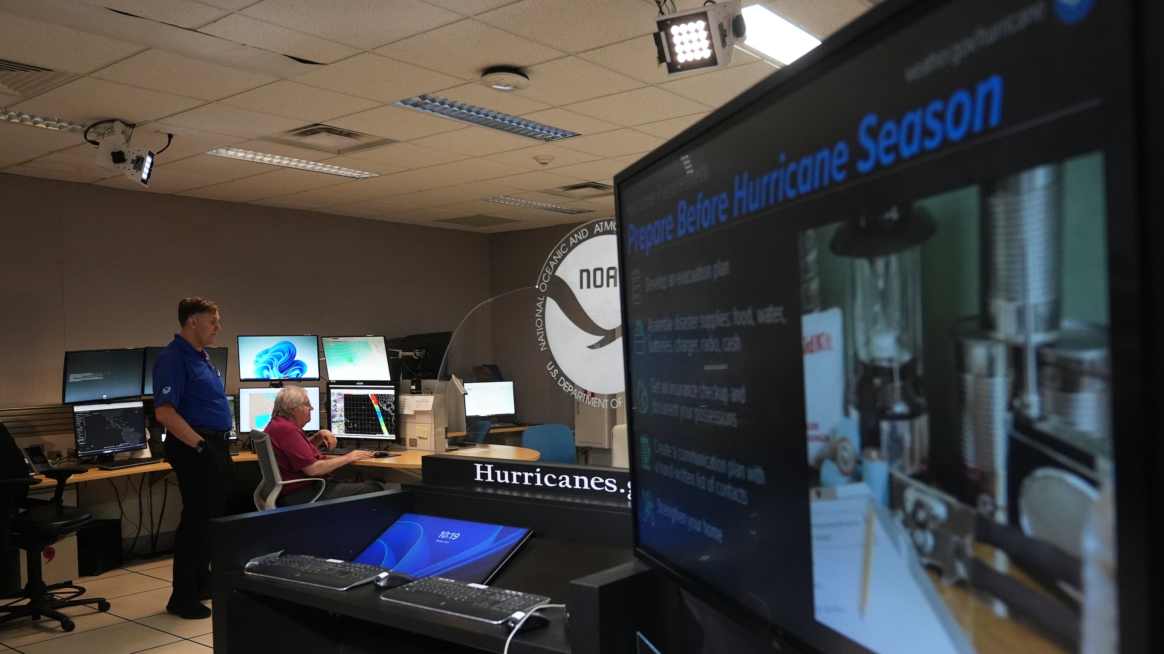 FILE - Senior hurricane specialists Eric Blake, left, and Richard Pasch, right, work at the National Hurricane Center on the first day of hurricane season, June 1, 2026, in Miami. (AP Photo/Lynne Sladky, File)