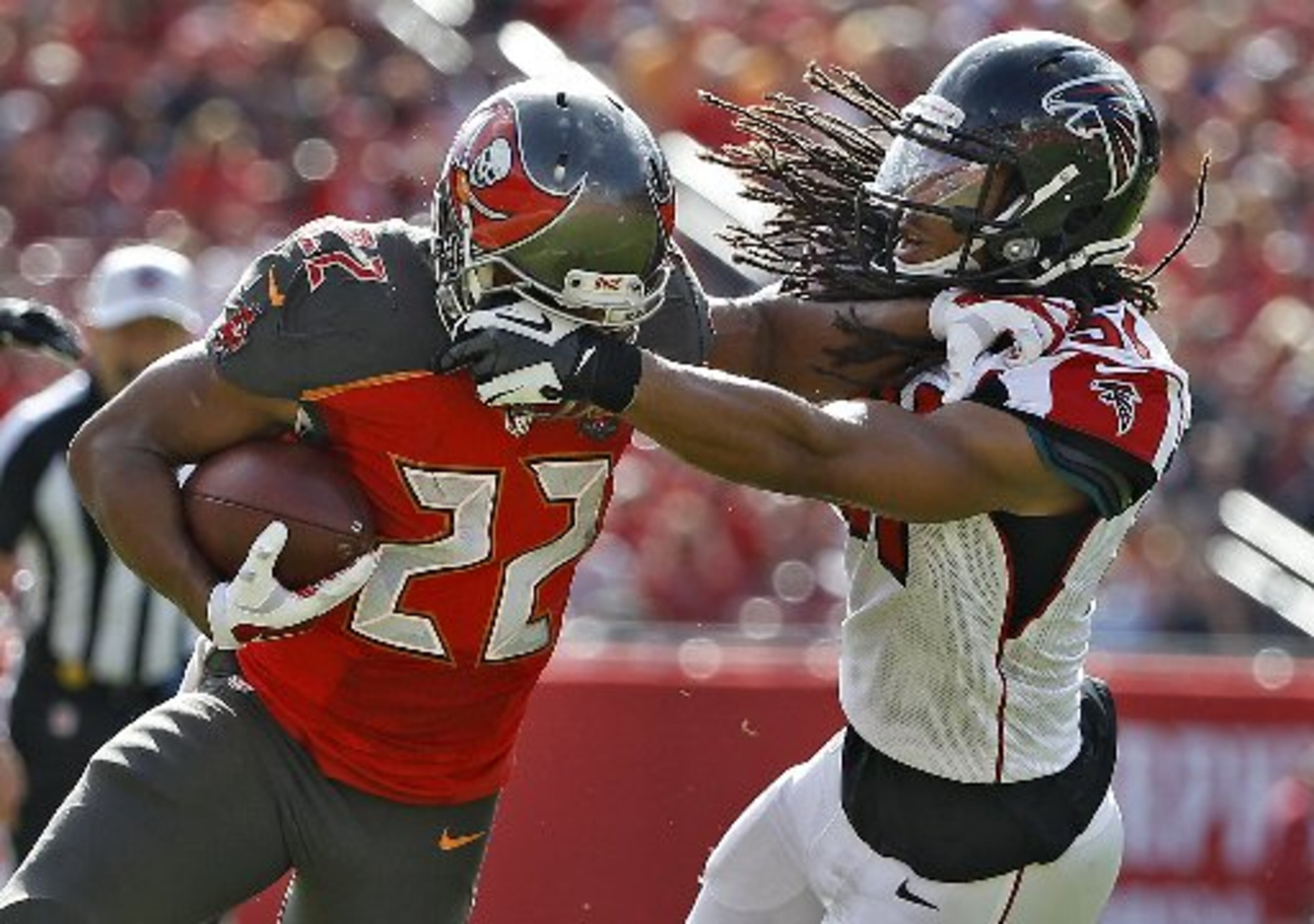 Atlanta Falcons outside linebacker Philip Wheeler (51) grabs Tampa Bay Buccaneers running back Doug Martin (22) by the fasemask during the first quarter of an NFL football game Sunday, Dec. 6, 2015, in Tampa, Fla. (AP Photo/Brian Blanco)