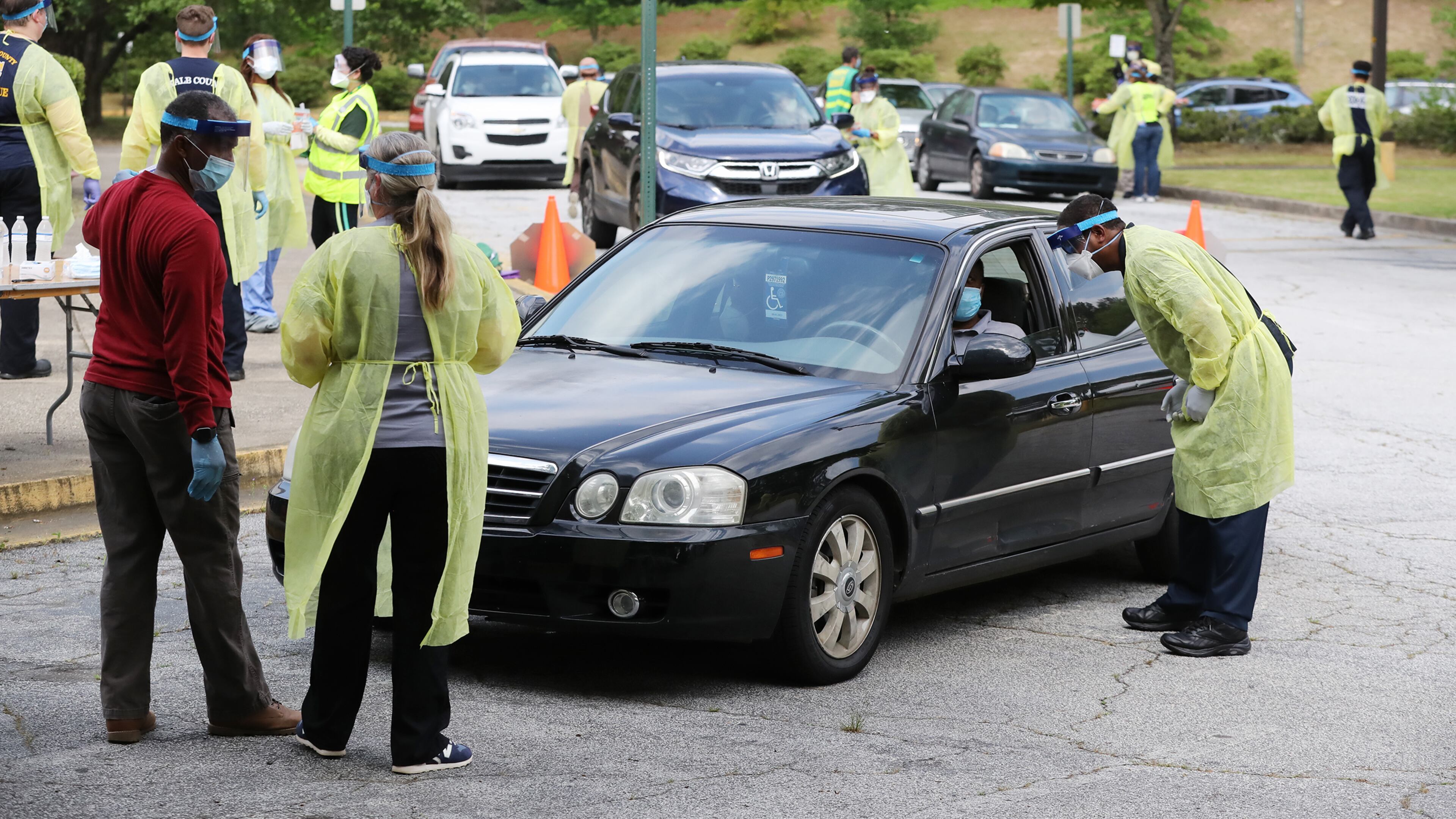 Some of the more than two dozen specimen collection volunteers perform free COVID-19 tests at a pop-up site at the House of Hope on Monday, May 4, in Decatur. Curtis Compton ccompton@ajc.com