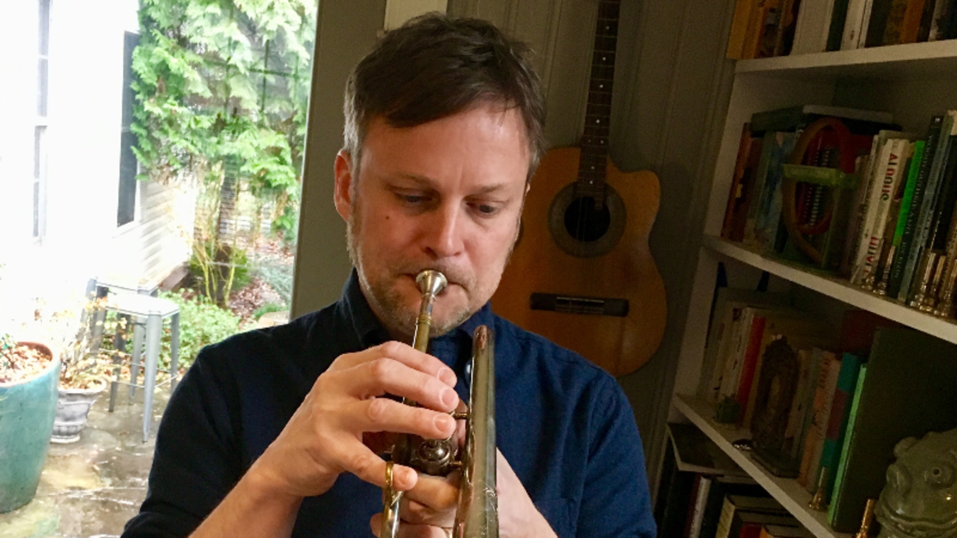 Matt Phillips playing the circa 1900 Three Star Boston cornet he restored. Bill Banks for the AJC