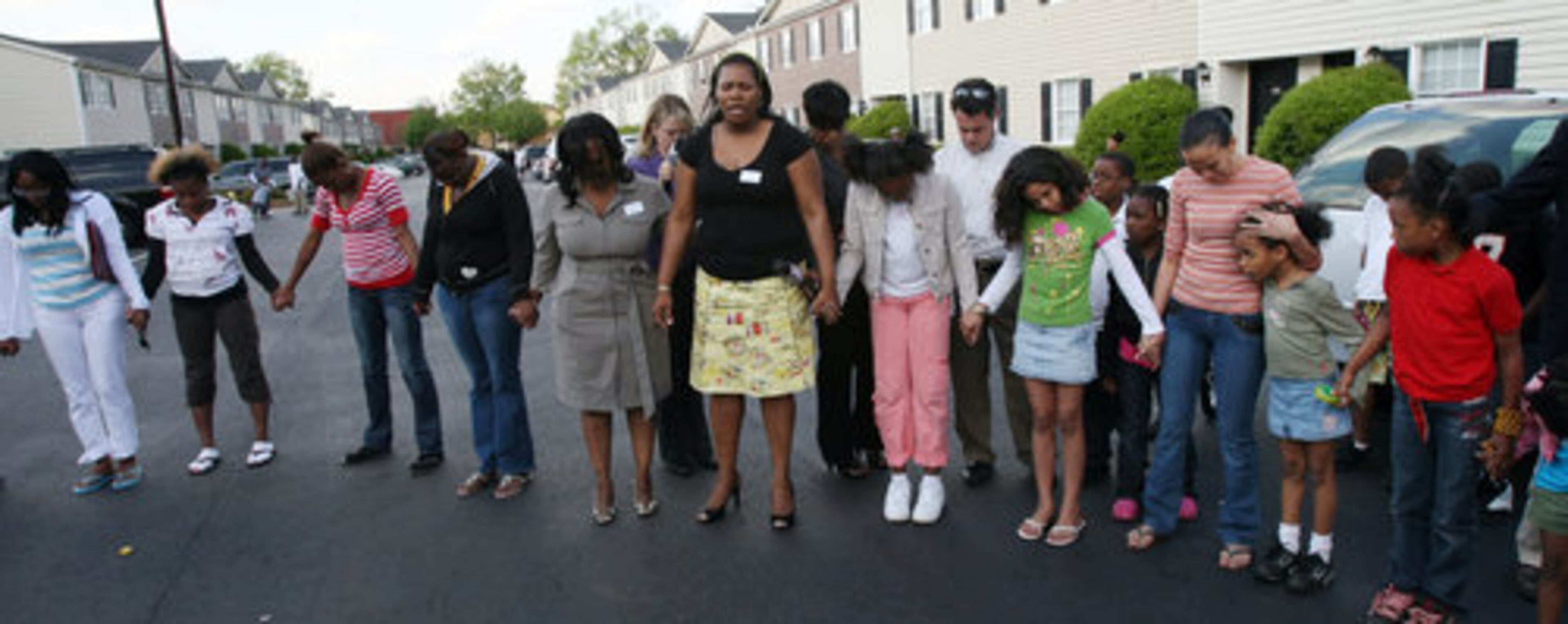 Masika Bermudez and her children are joined by family and friends in a "prayer circle" to remember her fifth-grade son outside the family's apartment in Dekalb County Tuesday night. The 11-year-old boy committed suicide Thursday after, according to his family, relentless bullying at Dunaire Elementary School. About 60 people attended the remembrance.