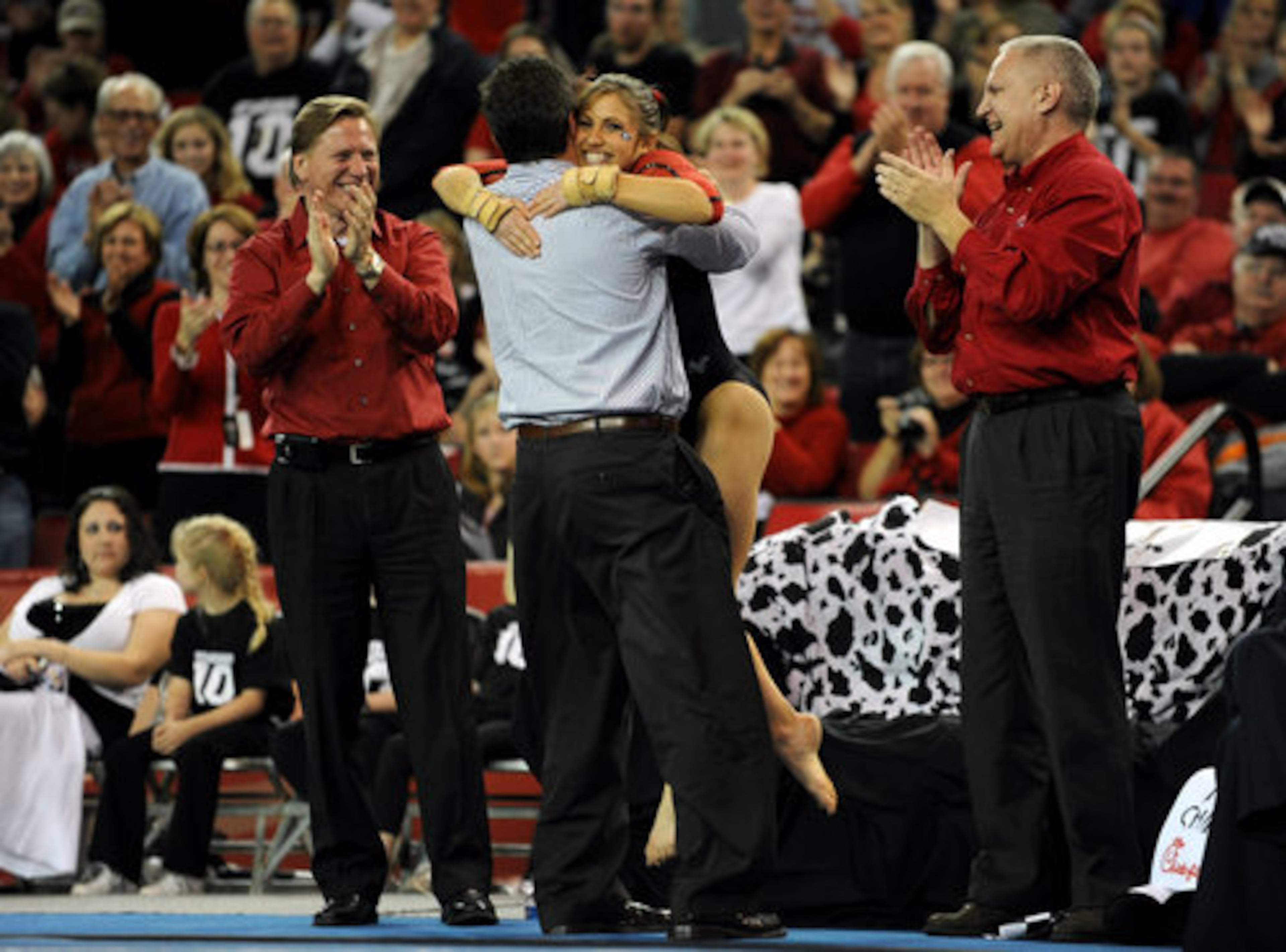Georgia Gym Dog Courtney Kupets is hugged by her father Mark Kupets following her floor routine on senior night, the last home meet of the year in Athens on March 14, 2009.