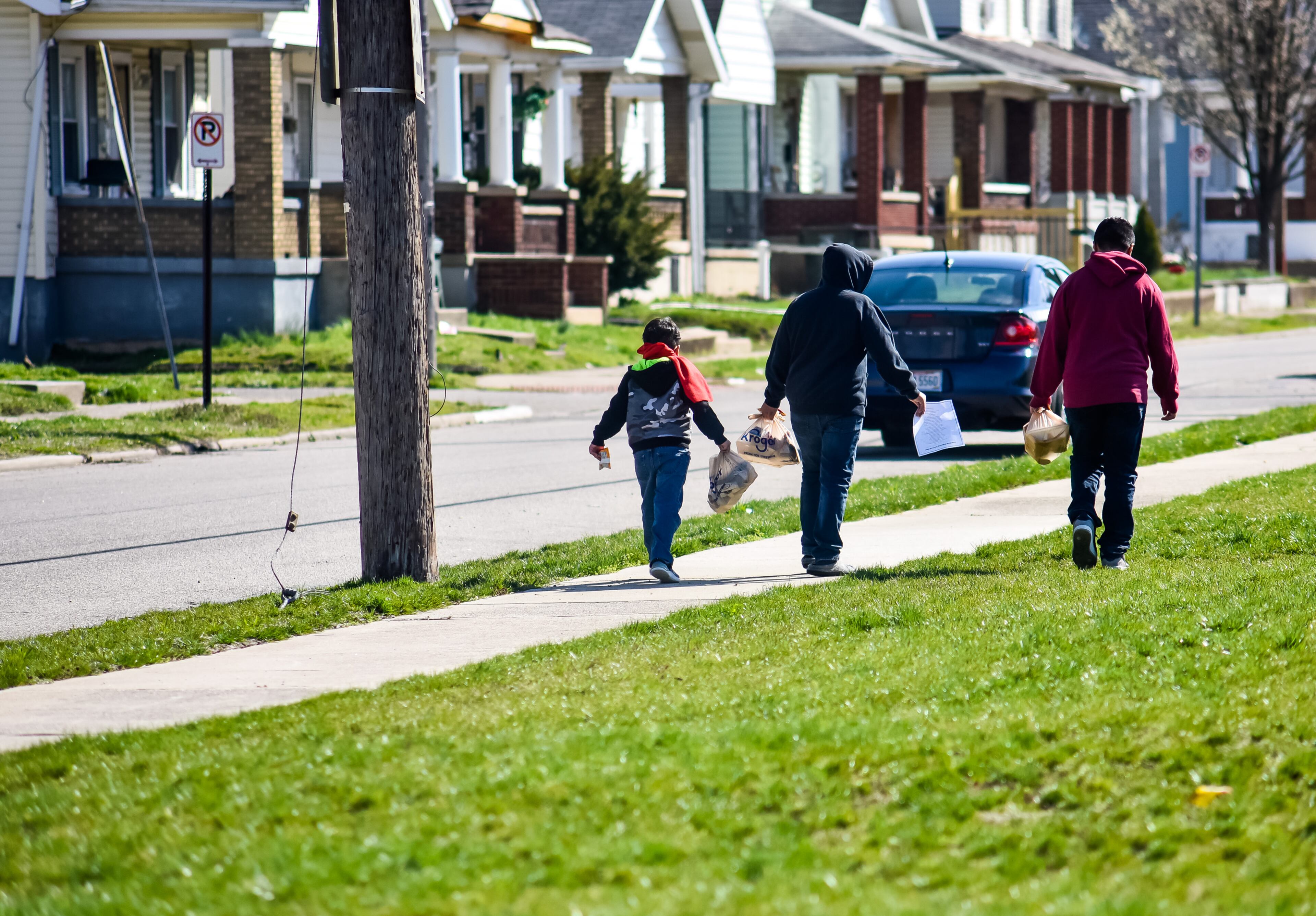 Three children carry lunches they received Thursday, March 26, 2020 at one of the lunch distribution stations put in place by Hamilton School District. Hamilton City Schools is among many schools in the area supplying students with meals throughout the week since school is out due to the coronavirus pandemic. Starting Monday March 30 they will be distributing meals two days a week, Mondays and Wednesdays, at nearly 30 locations. Monday's meal bag will include 2 breakfasts and 2 lunches and Wednesday's bag will include 3 breakfasts and 3 lunches. NICK GRAHAM / STAFF