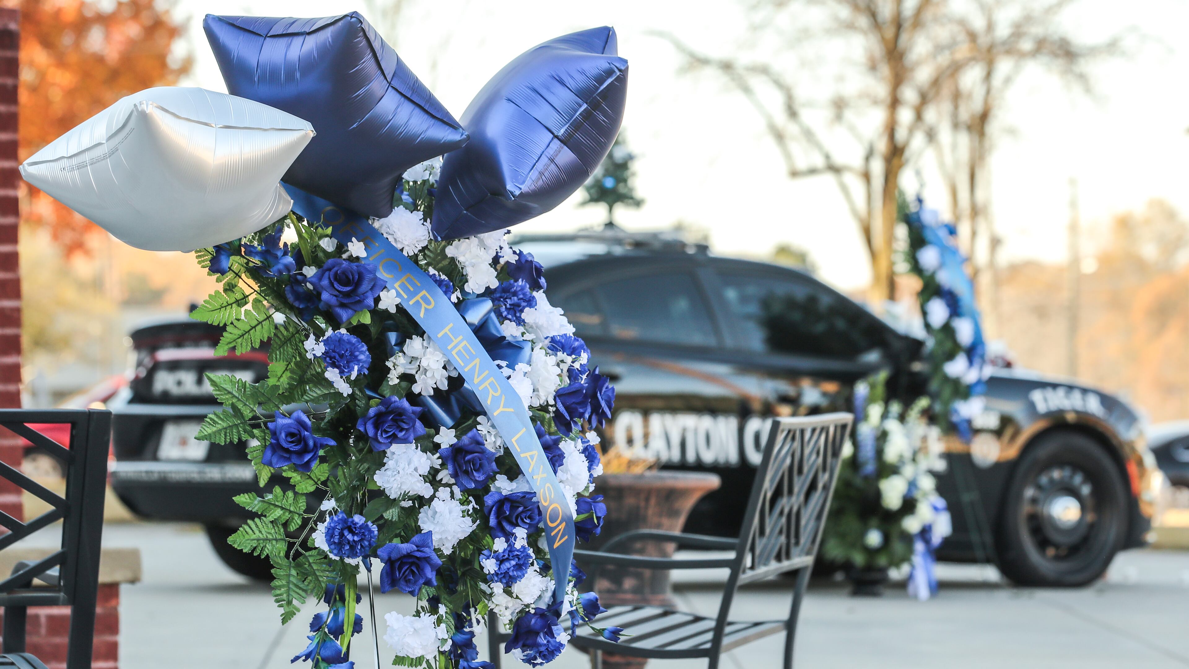Henry Laxson’s patrol car was parked in front of Clayton County police headquarters for those wanting to drop off flowers or other gifts to honor him.