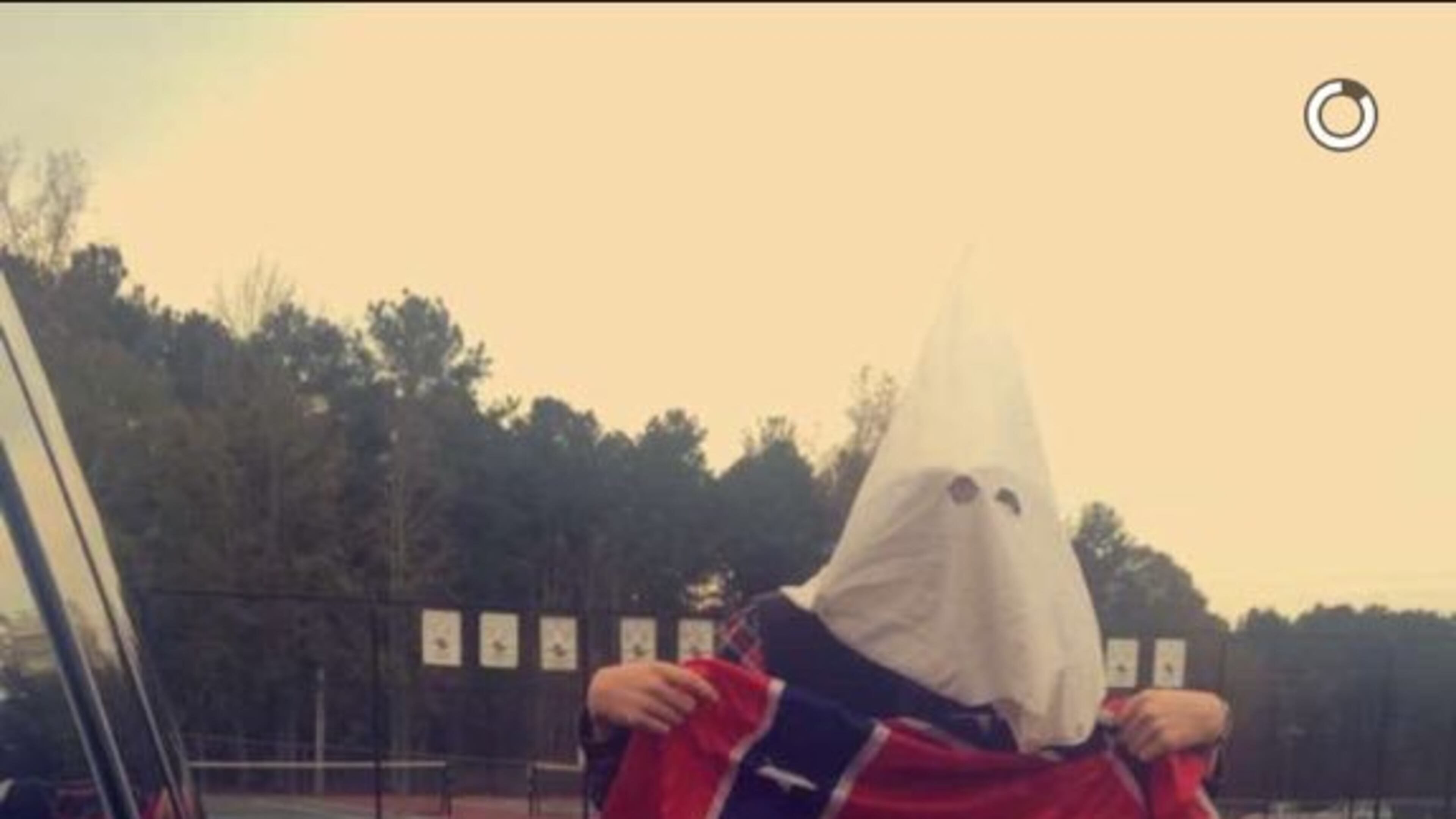 East Coweta High School officials are investigating a photograph of one of their students supposedly wearing a KKK hood.